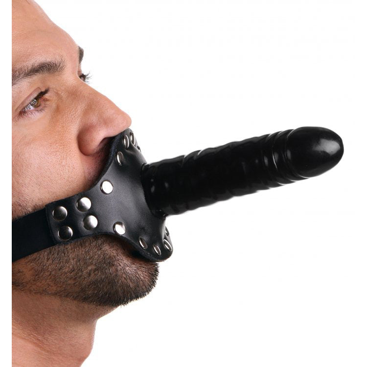 A person wearing a black leather mouth gag with strap