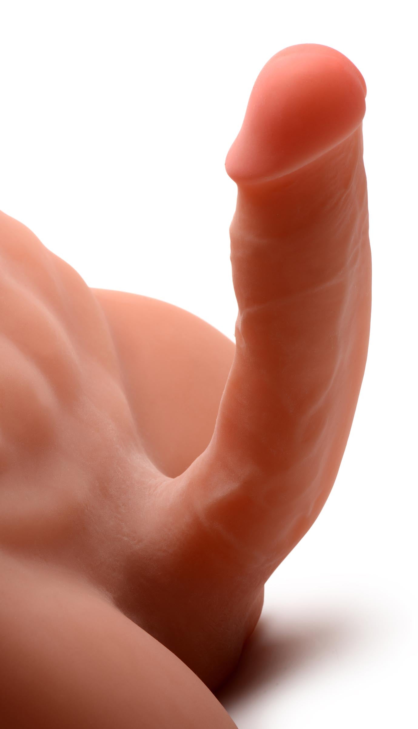 Close-up view of a realistic adult toy designed to resemble a male lower torso on a white background