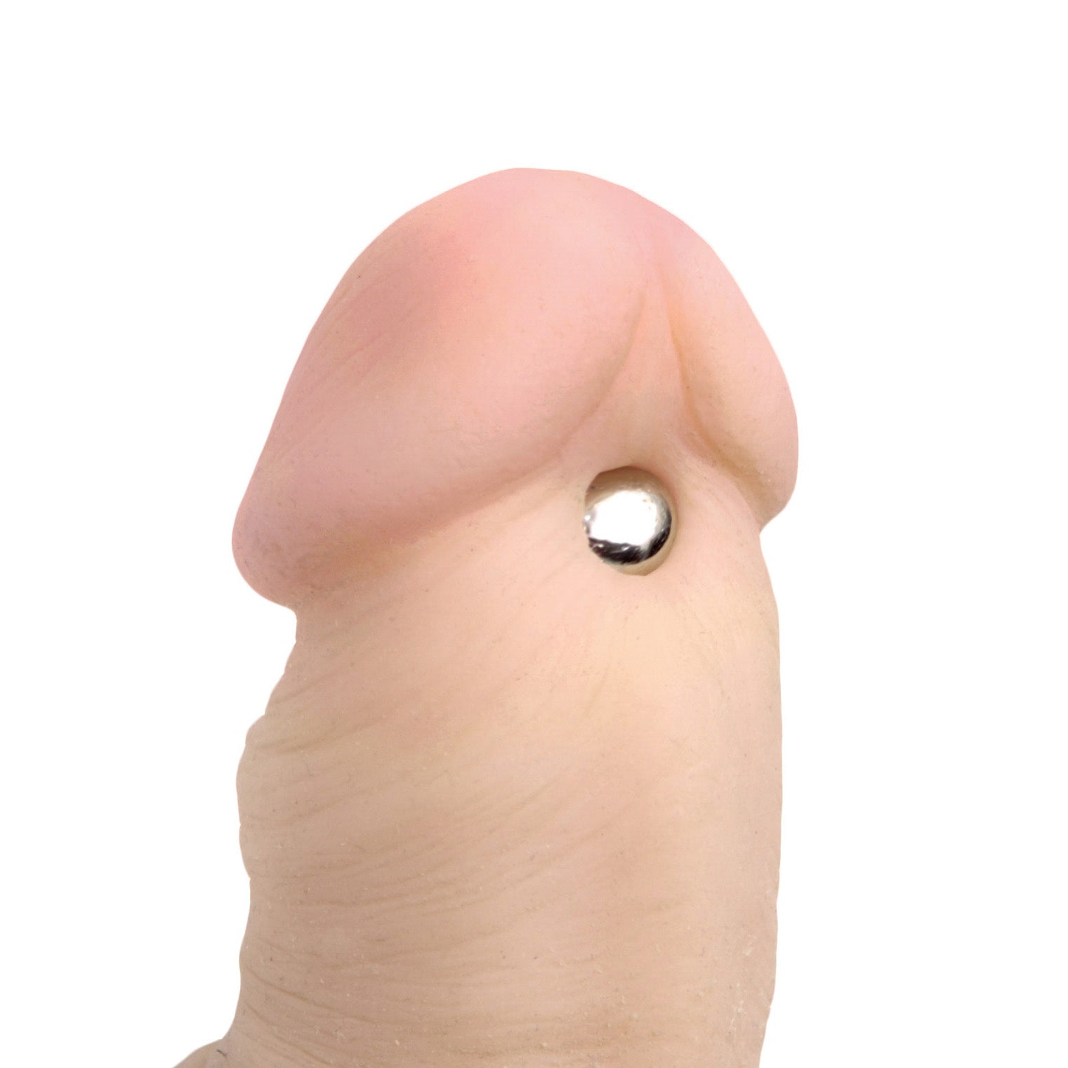 A person's finger holding one of the Magnus Mighty Magnetic Orbs