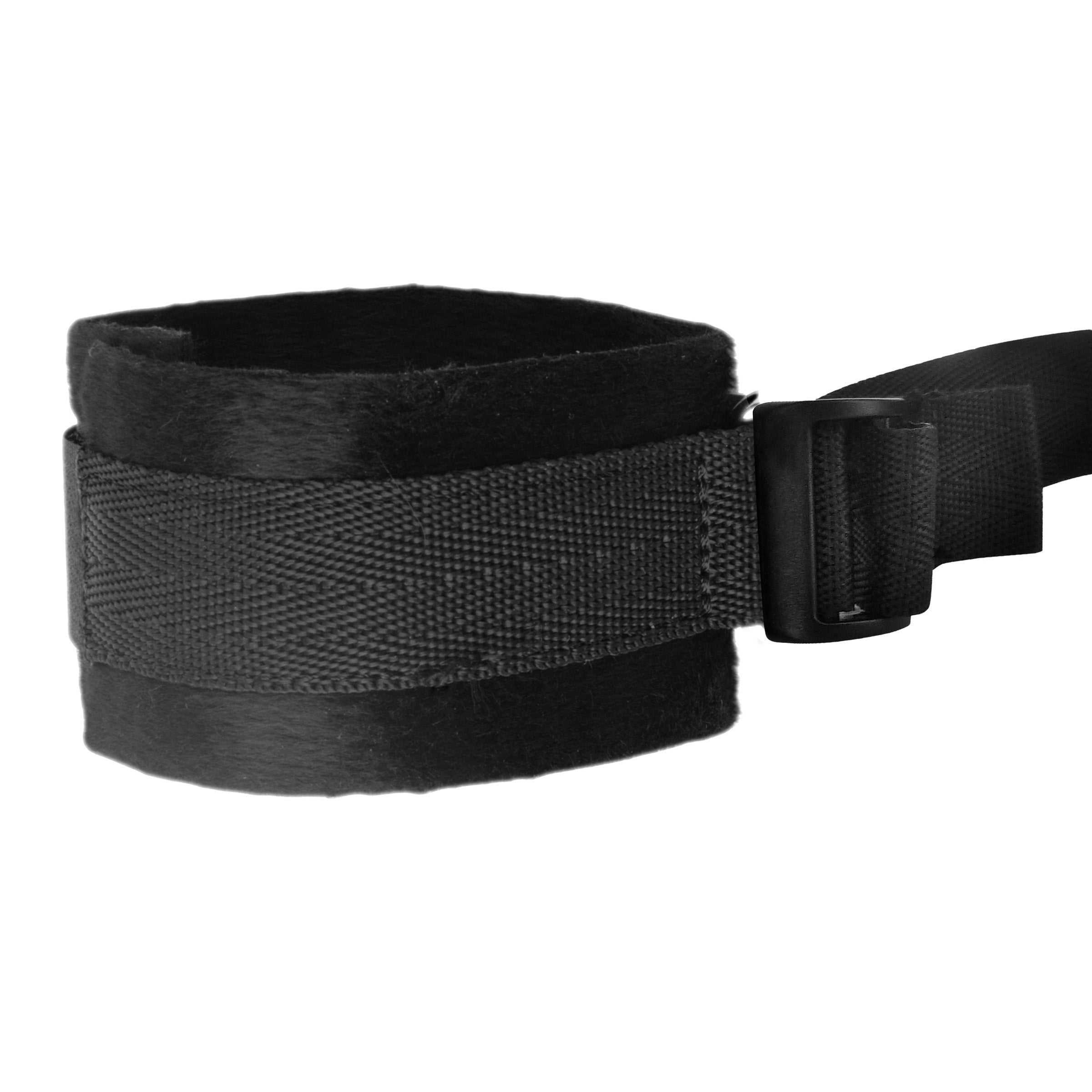 Close-up of a black restraint strap with a secure buckle, part of the restraint system