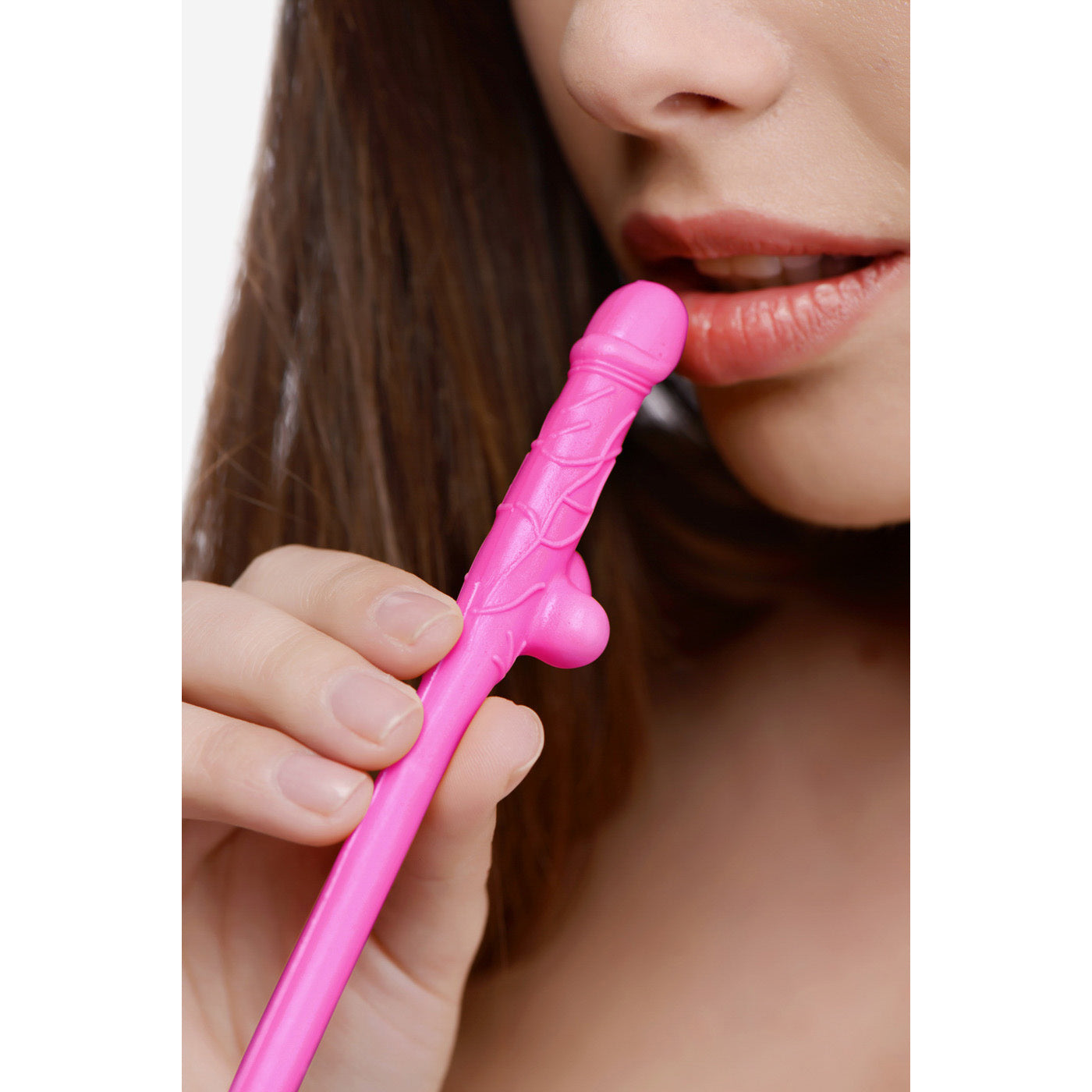 A person holding a pink penis-shaped sipping straw from the 10 pack