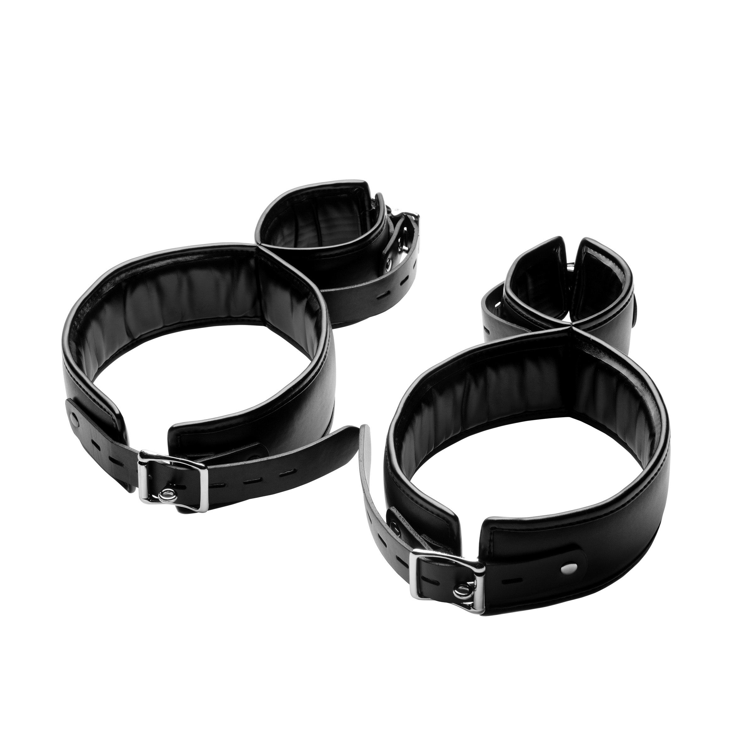 Close-up of black leather thigh cuff restraints with metal hardware