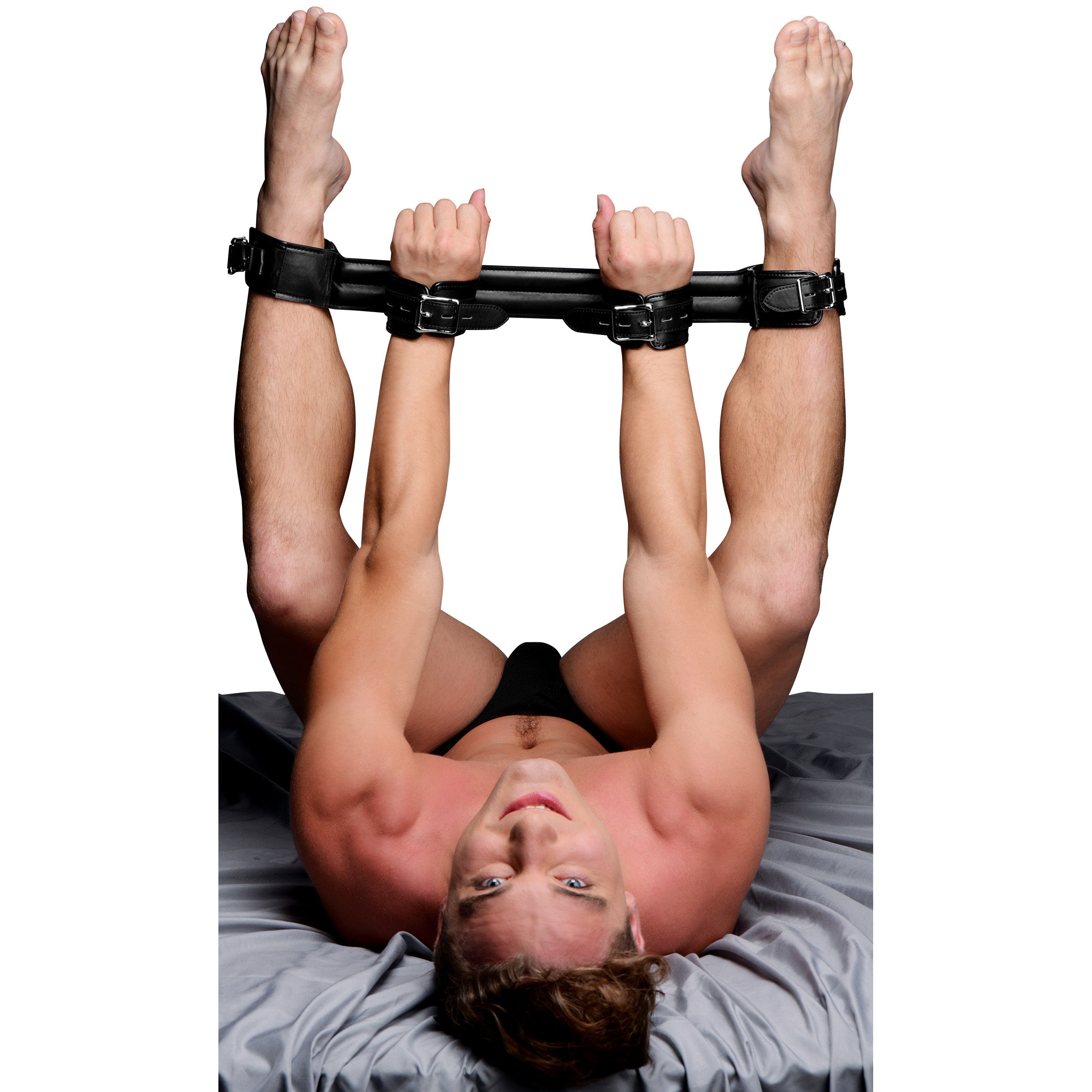 Deluxe Rigid Spreader Bar in use by a person lying on their back with wrists secured