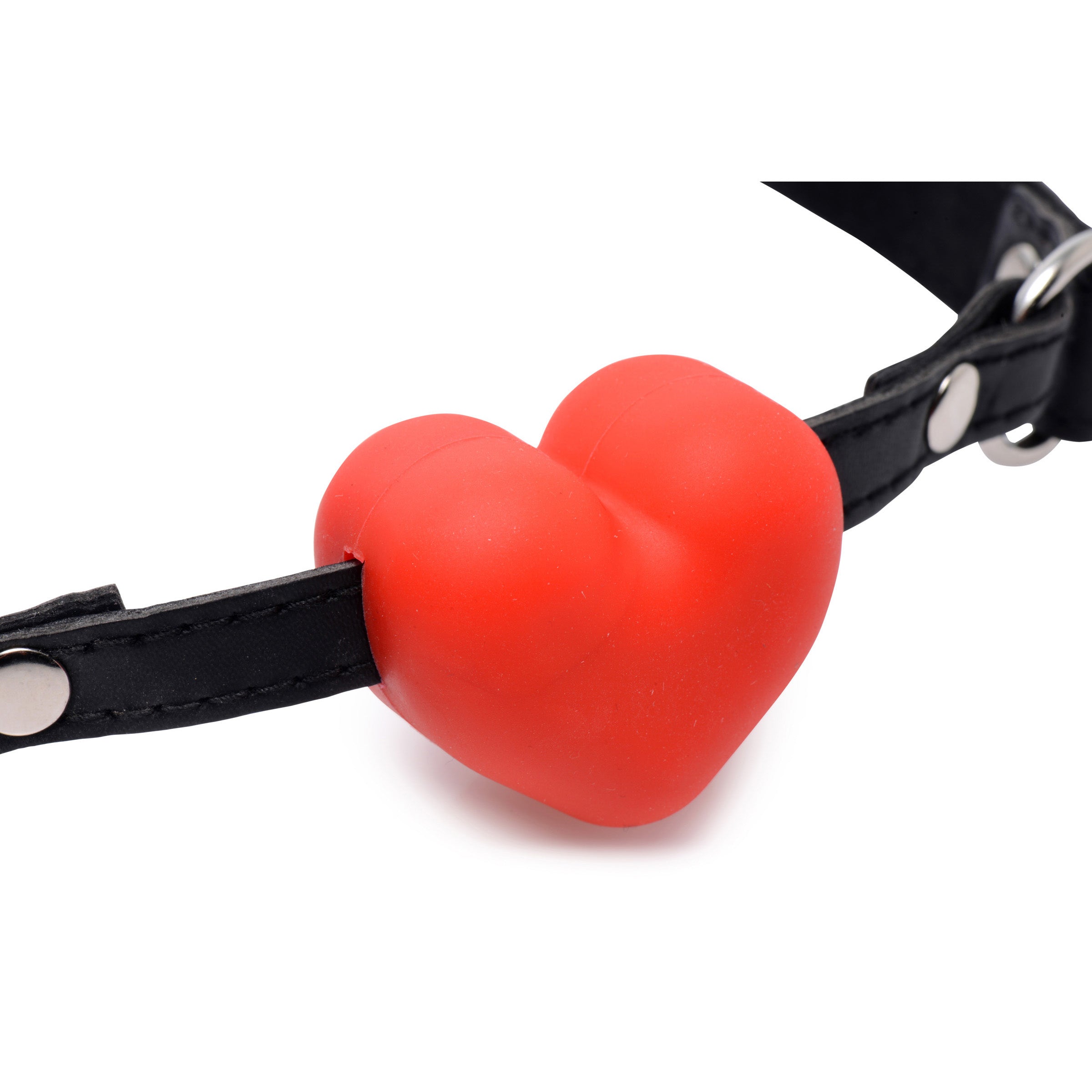 A red silicone heart-shaped mouth gag attached to a leather strap