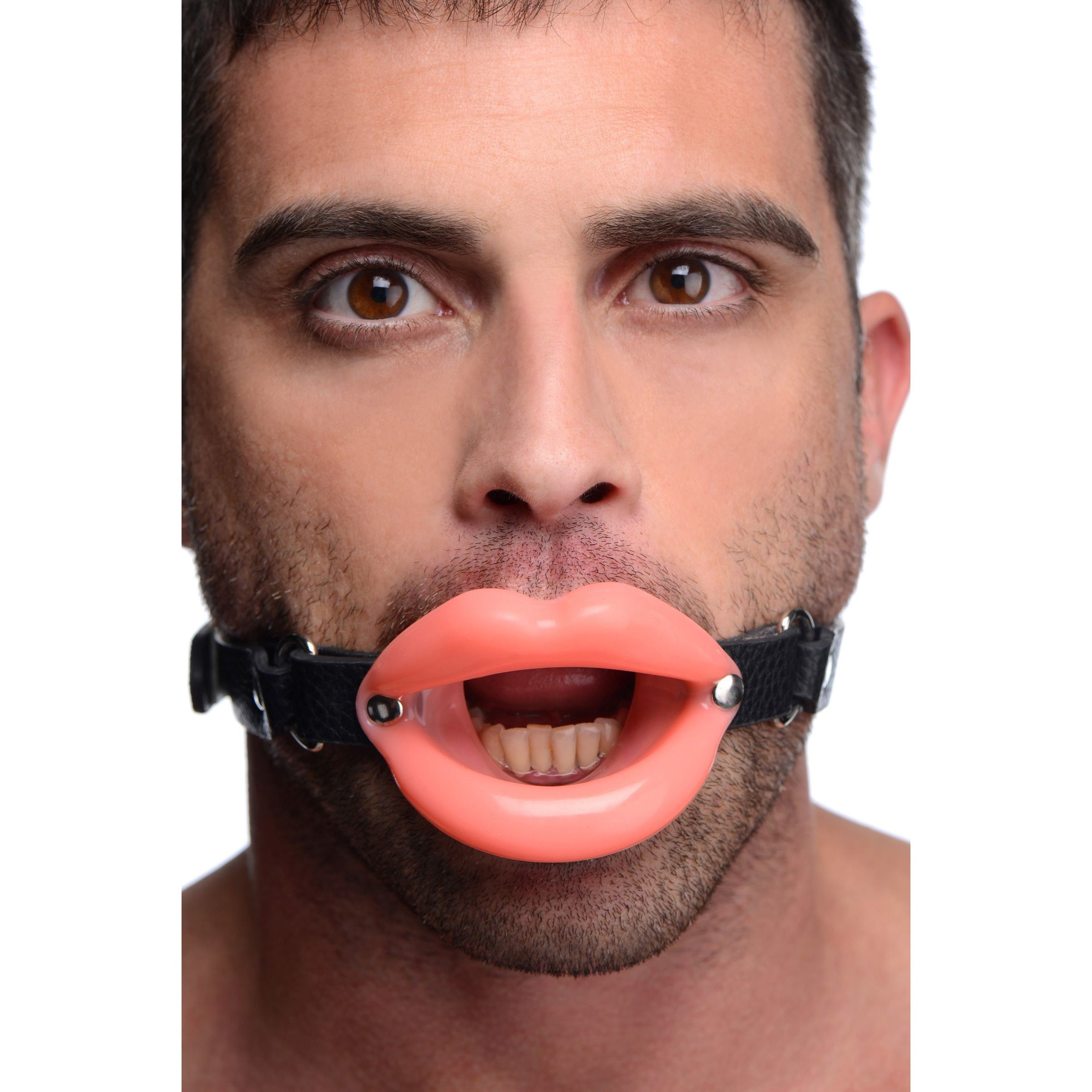 Man presenting a sissy mouth gag with straps in front of him