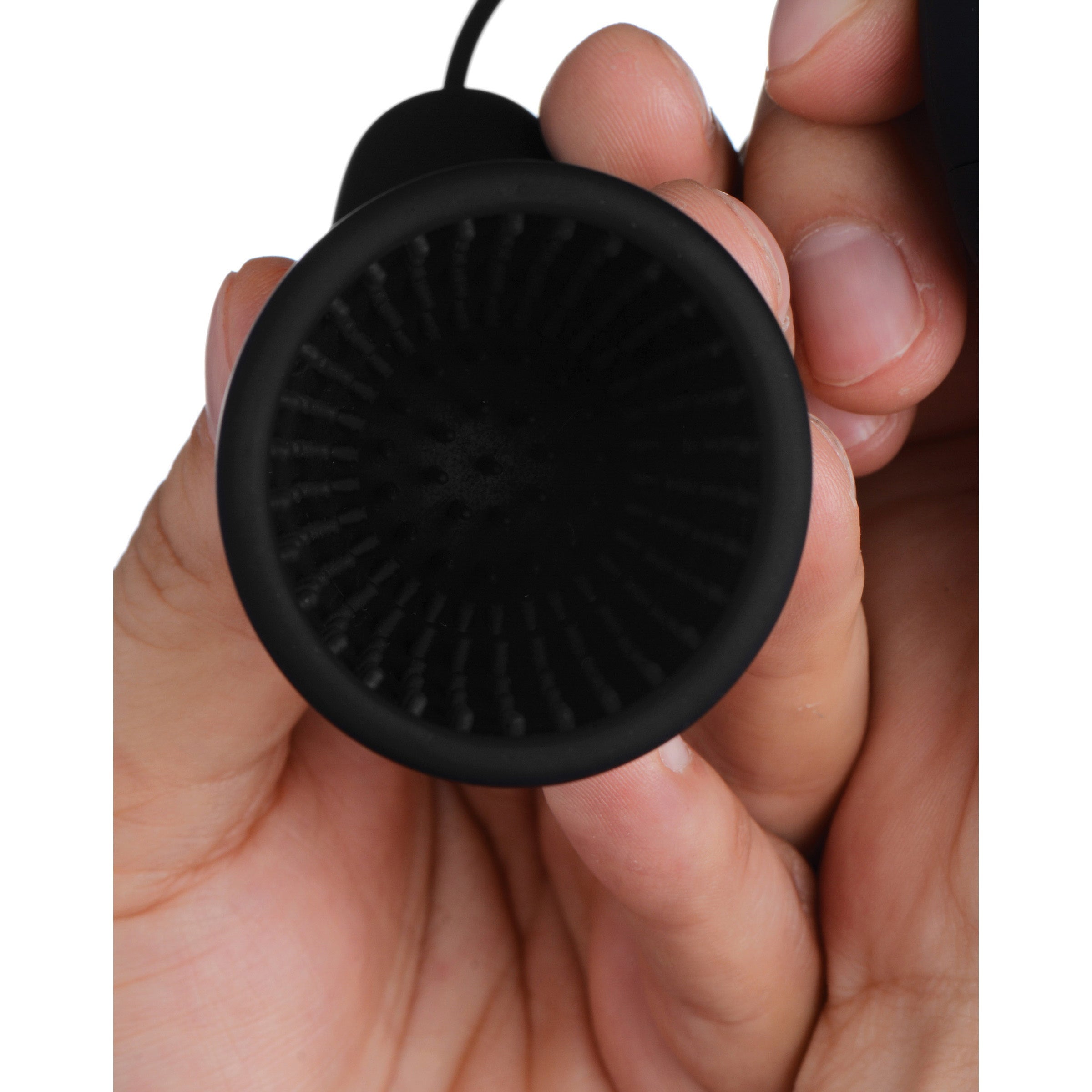 Individual holding the Deluxe 10 Mode Silicone Penis Head Teaser to show size and texture