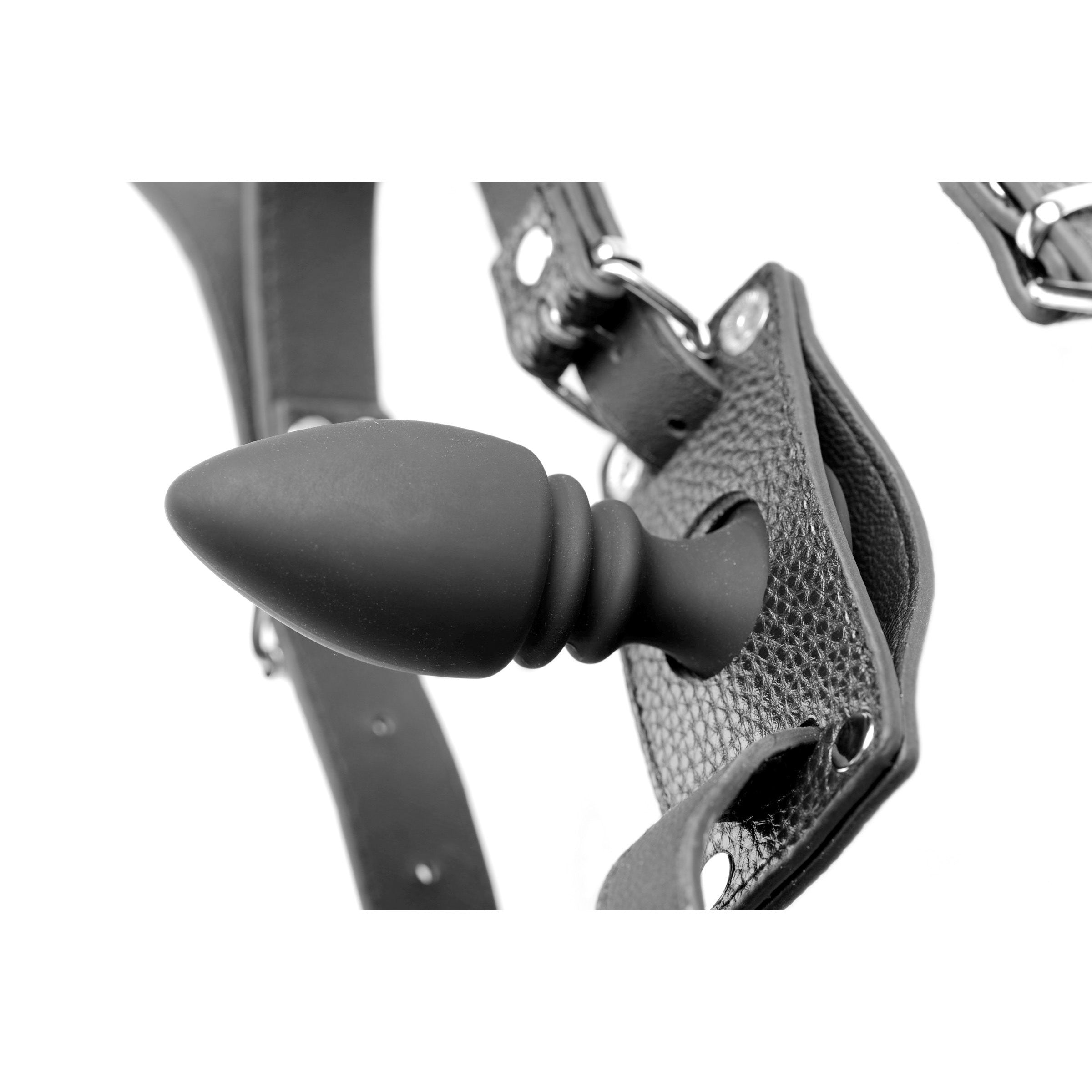 Monochrome image showcasing the cock ring harness with silicone anal plug