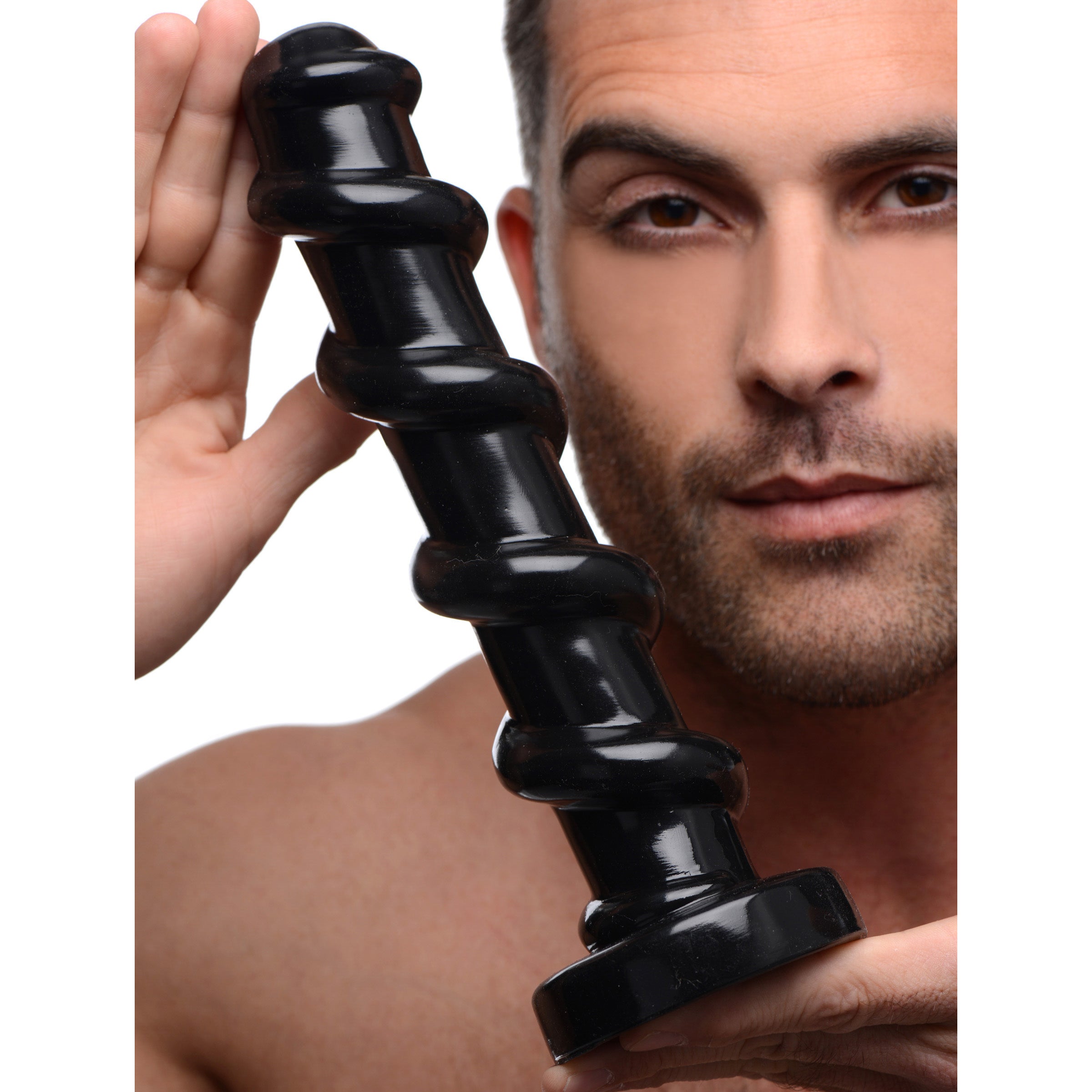 An individual presenting the Mighty Screw 9.5 Inch Dildo with a focus on the handle