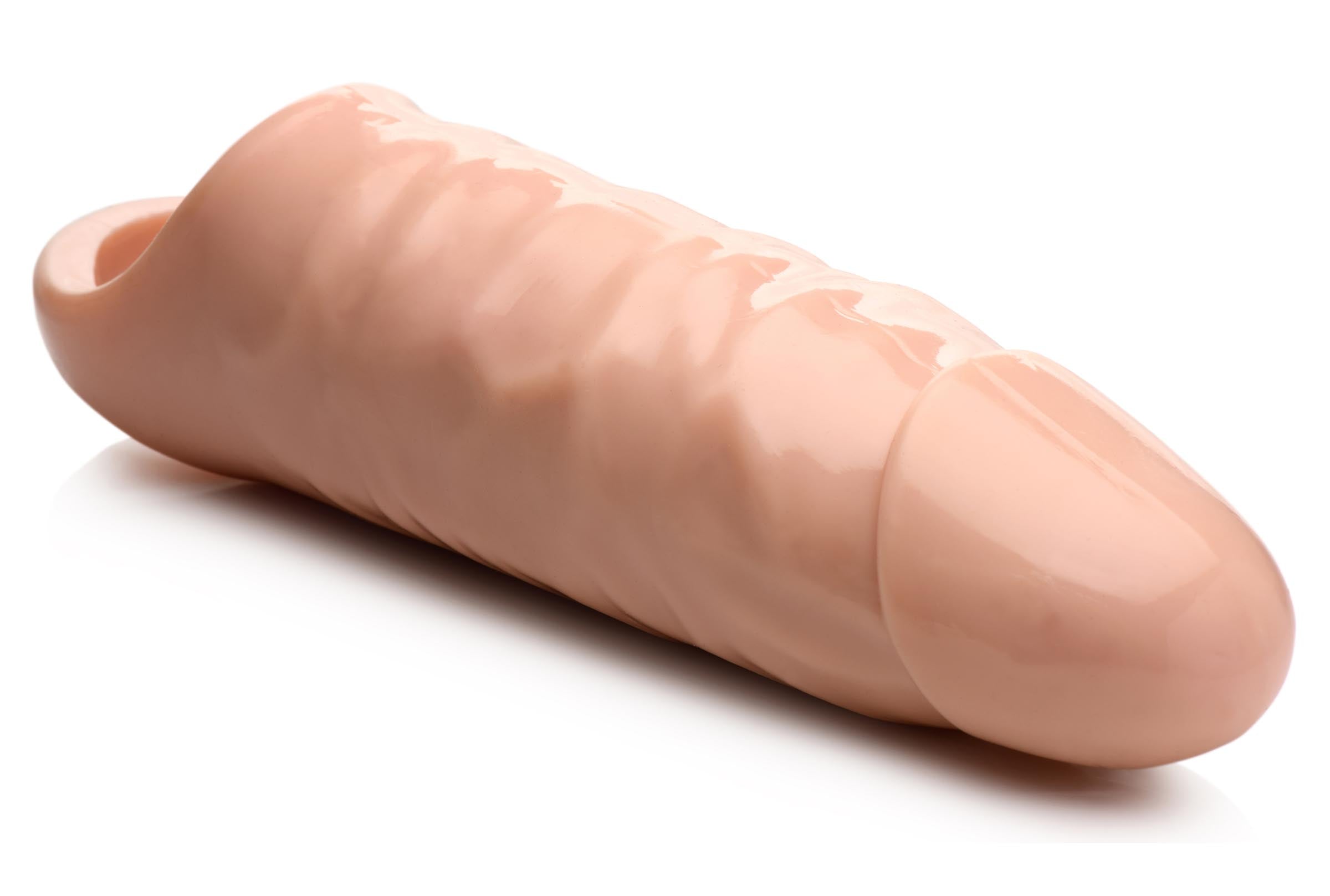 Pink 7-inch wide penis extension on a white surface