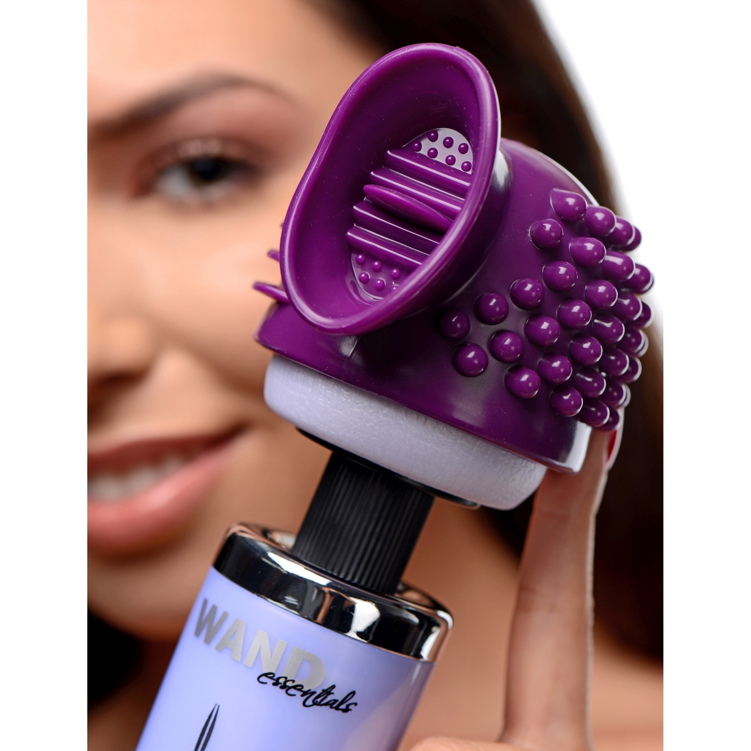 Person displaying the Triple Thrill 3 in 1 wand attachment in purple