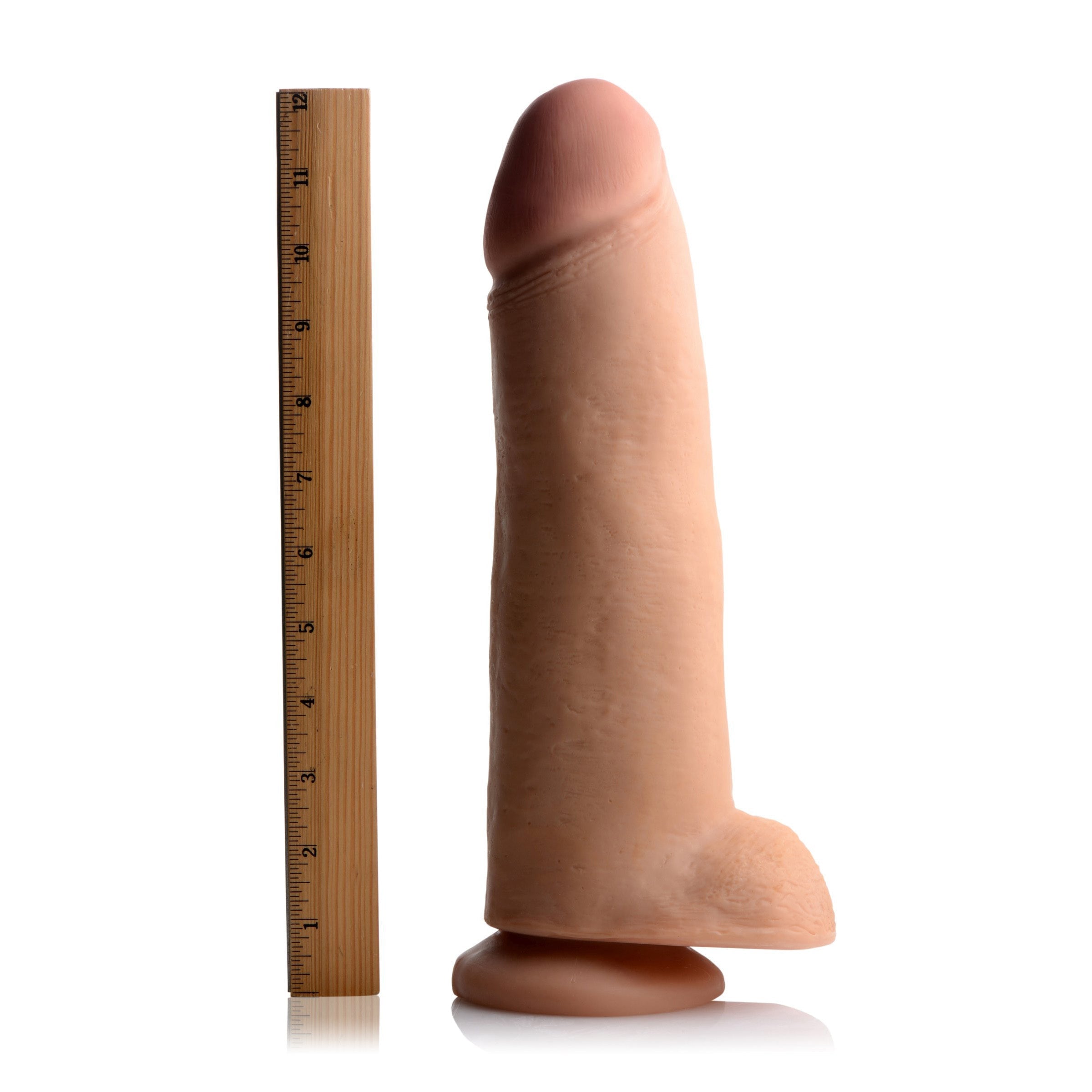 The Cody Skintech Realistic 12 Inch Dildo shown next to a ruler for scale