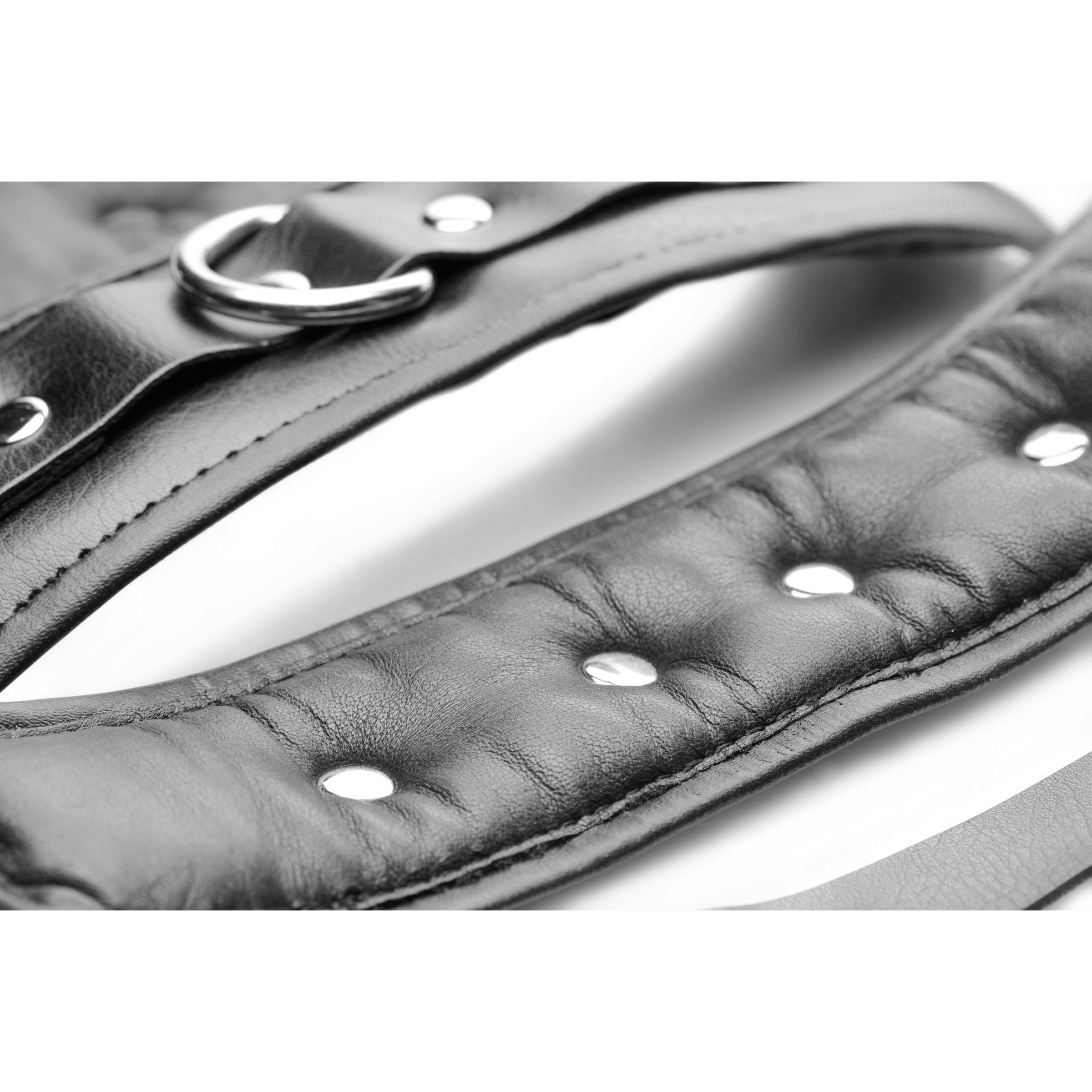 Detailed view of the buckle on leather bondage cuffs