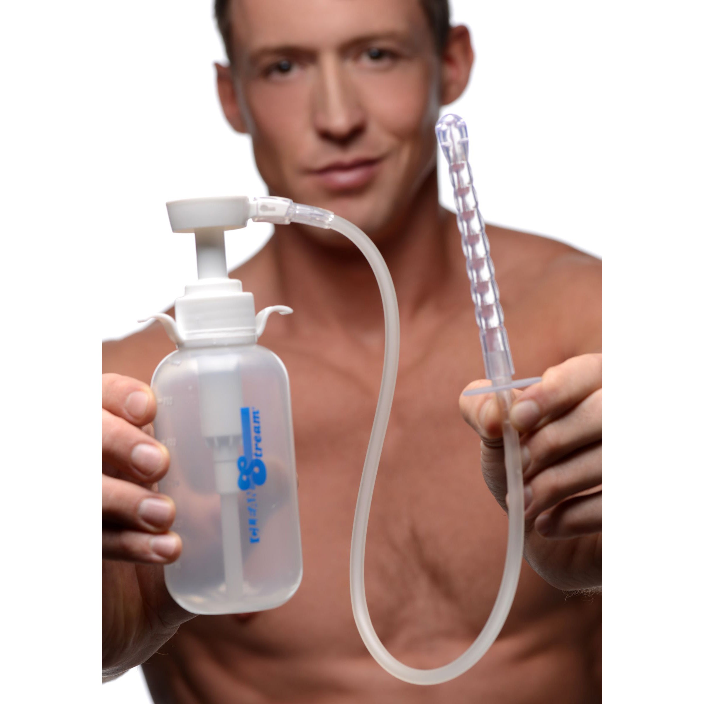 Man holding a pump action enema bottle with attached nozzle