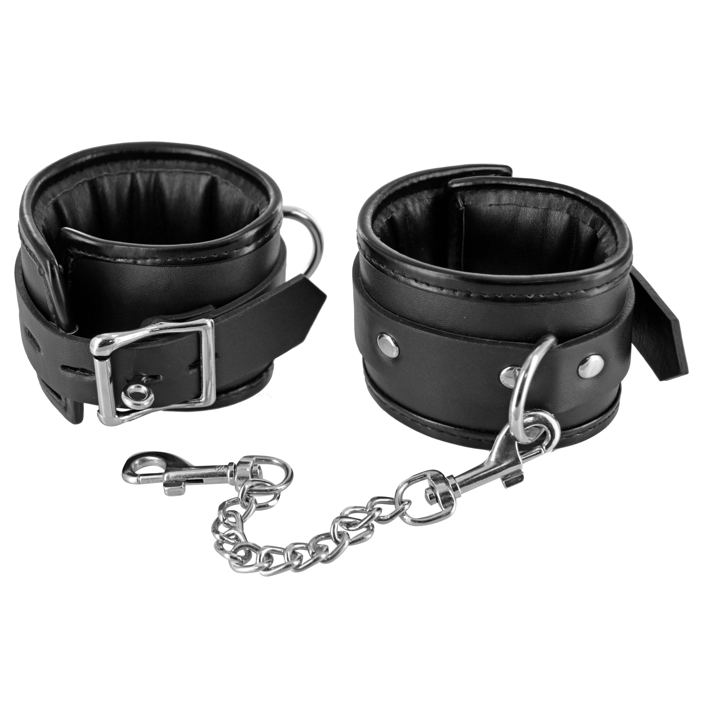 Pair of black leather cuffs with connecting metal chains, part of the 'Kneel Before Me Bondage Kit'