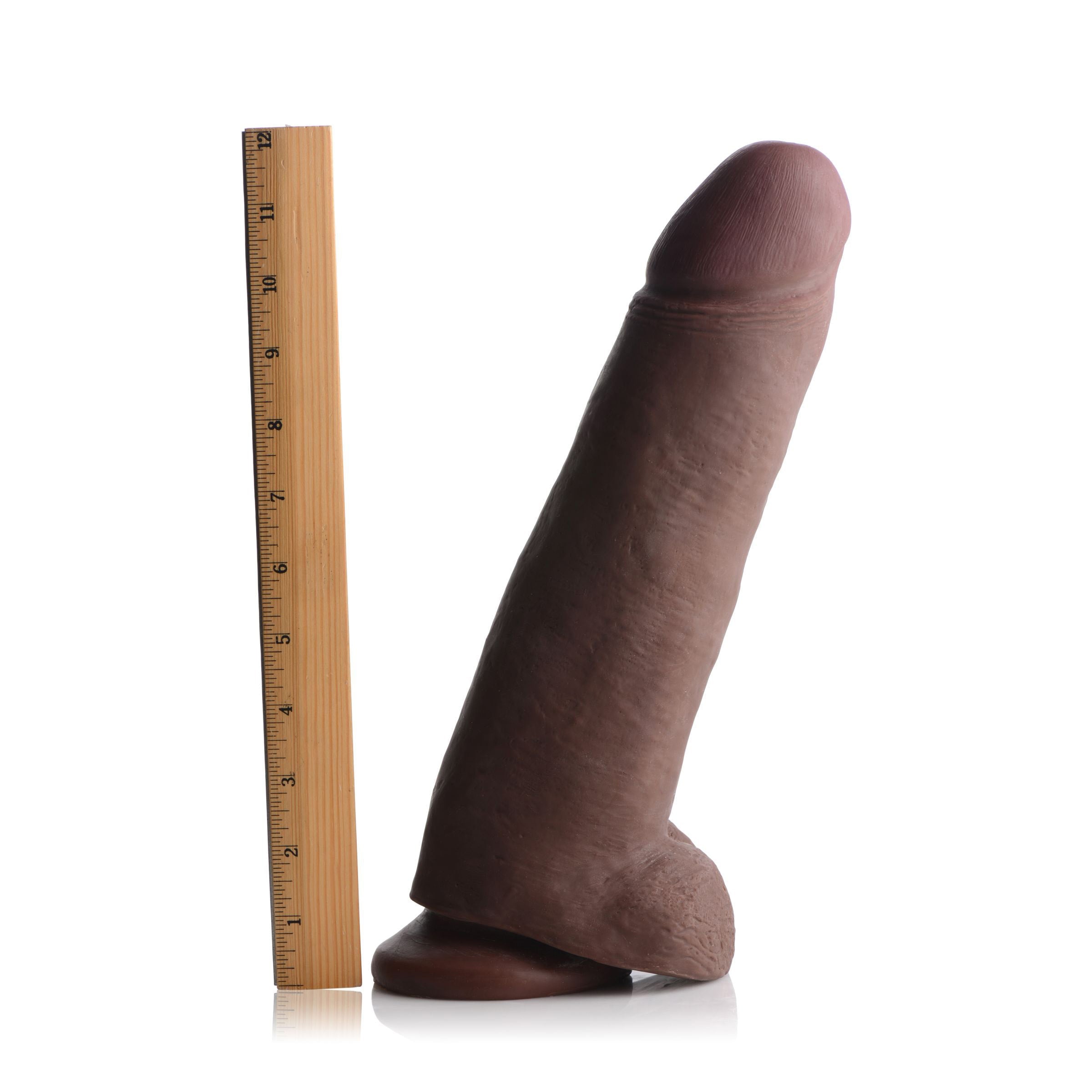 Andre Bbc Skintech Realistic 12 Inch Dildo positioned adjacent to a measuring ruler for scale