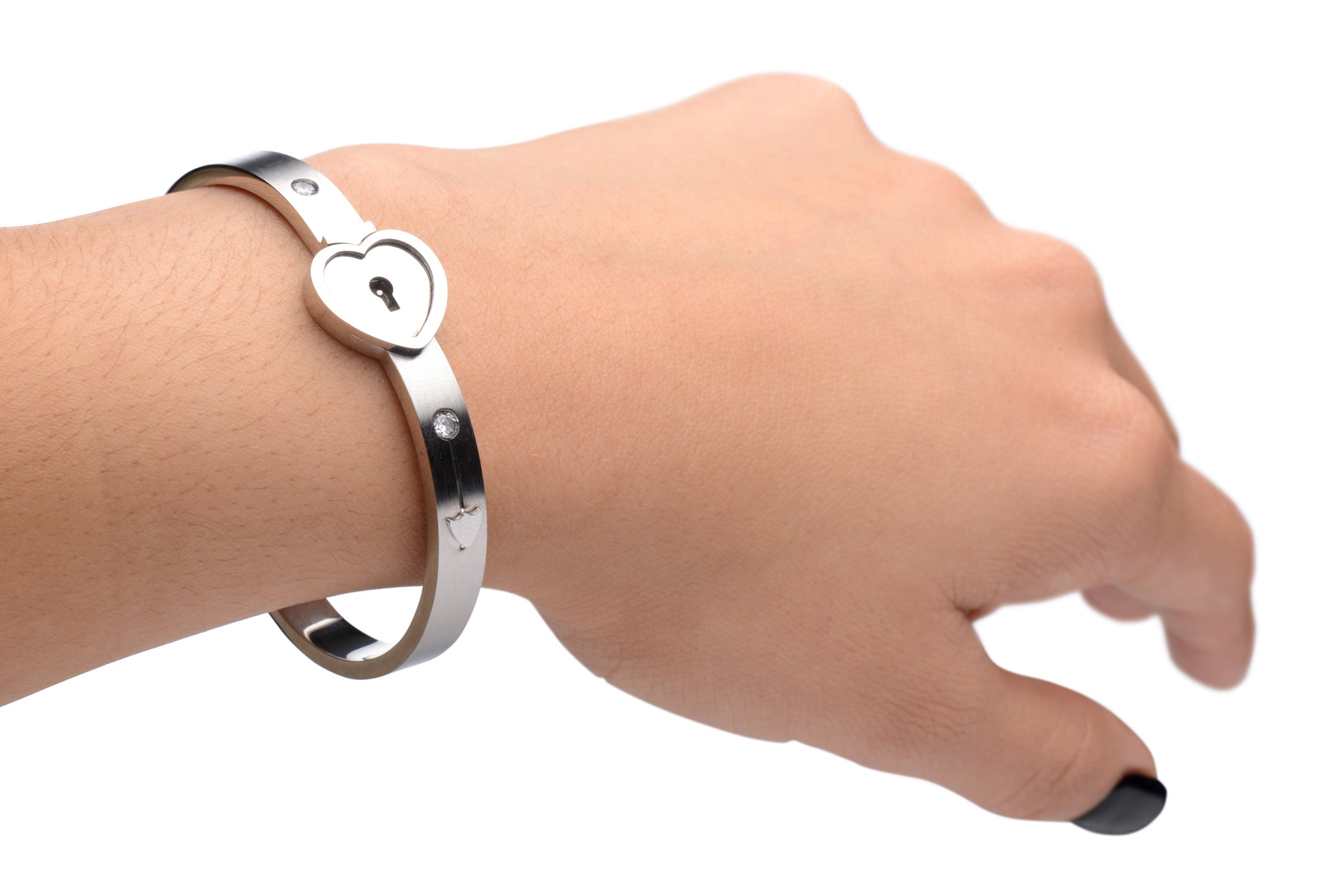 Close-up of a silver bracelet with a heart-shaped lock held by a woman