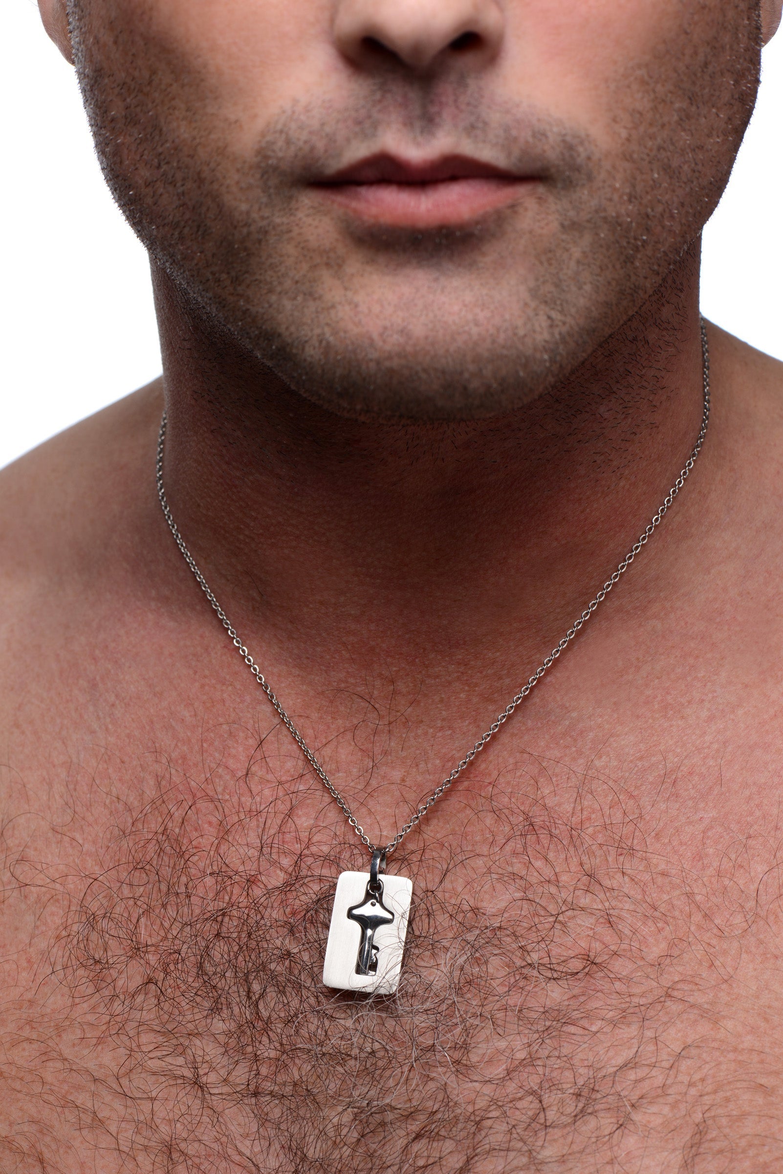 Man wearing a silver necklace featuring a key pendant designed to match a locking bracelet