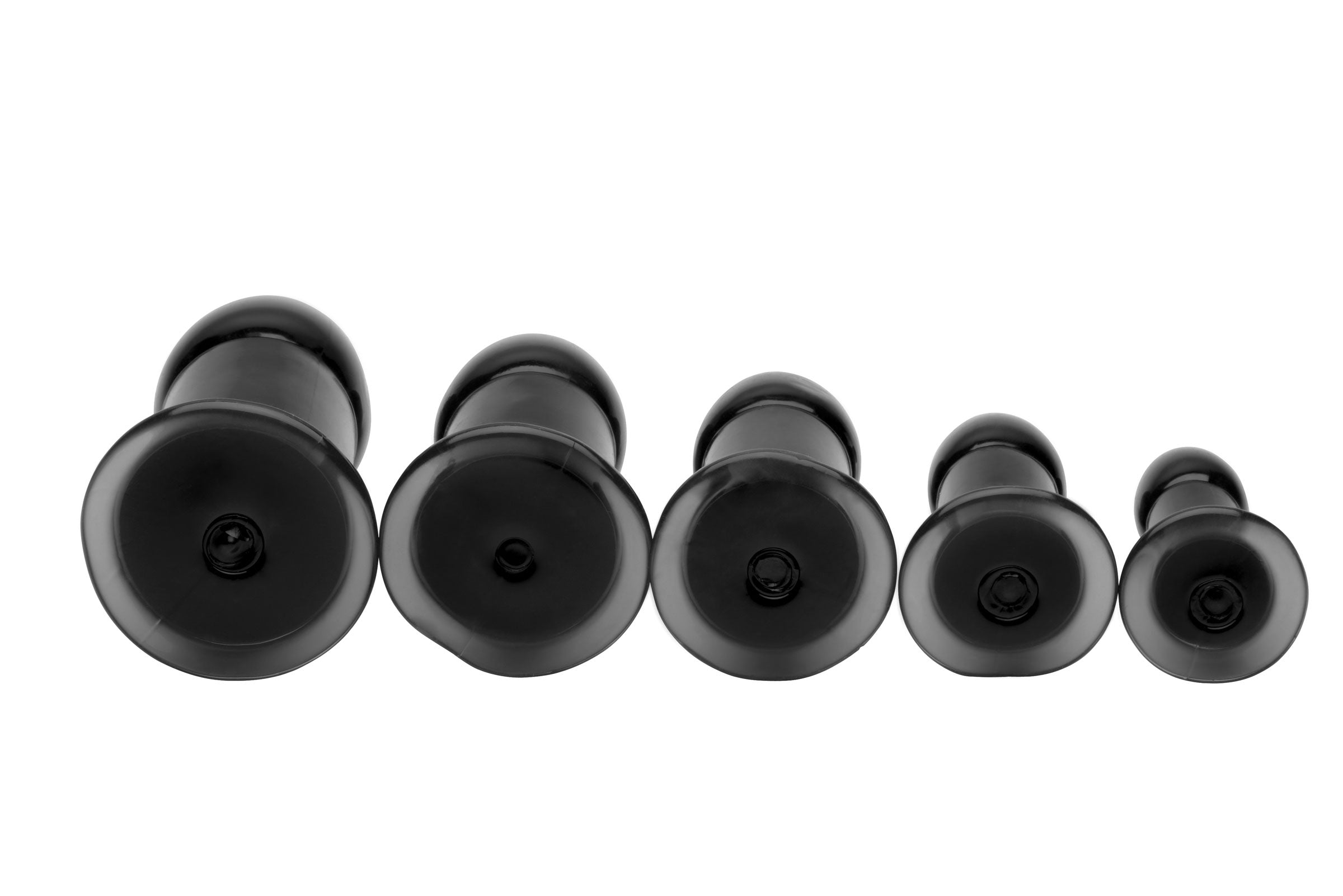 Several black butt plugs aligned in ascending size order for gradual training