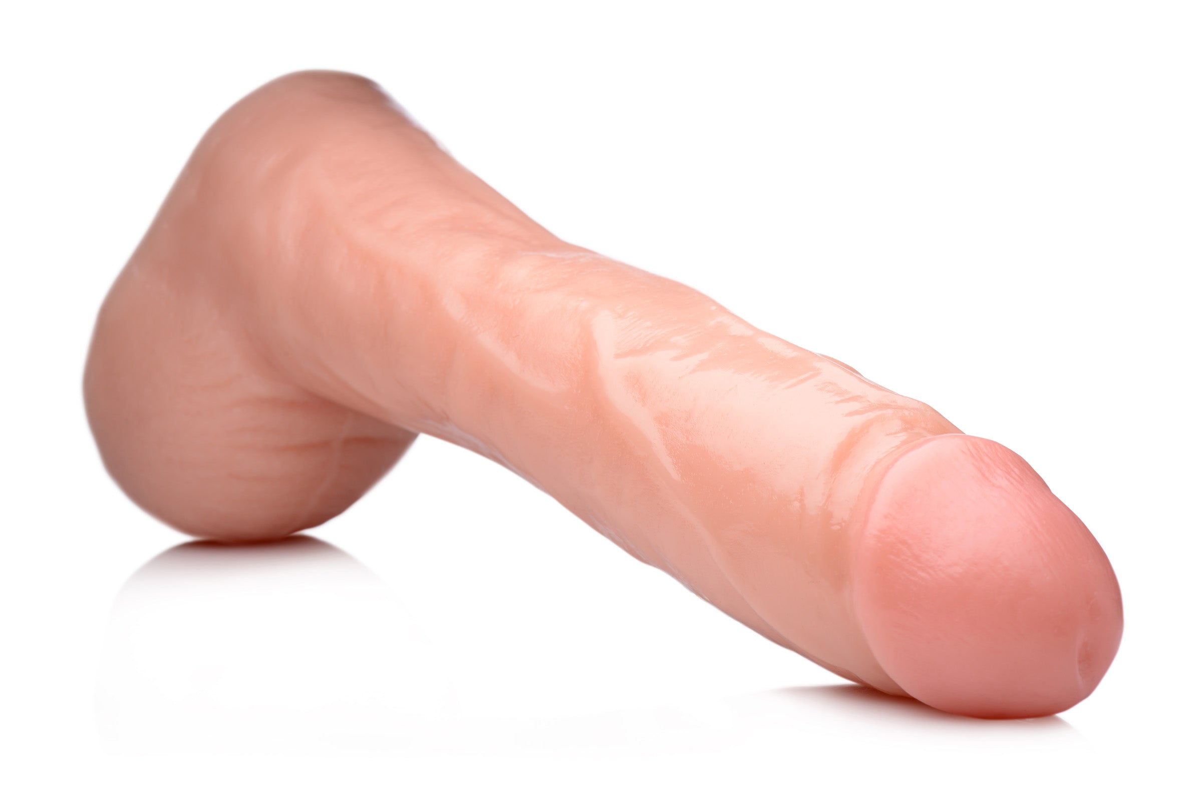 Side view of a 10-inch cock lock dildo with testicles on a white surface