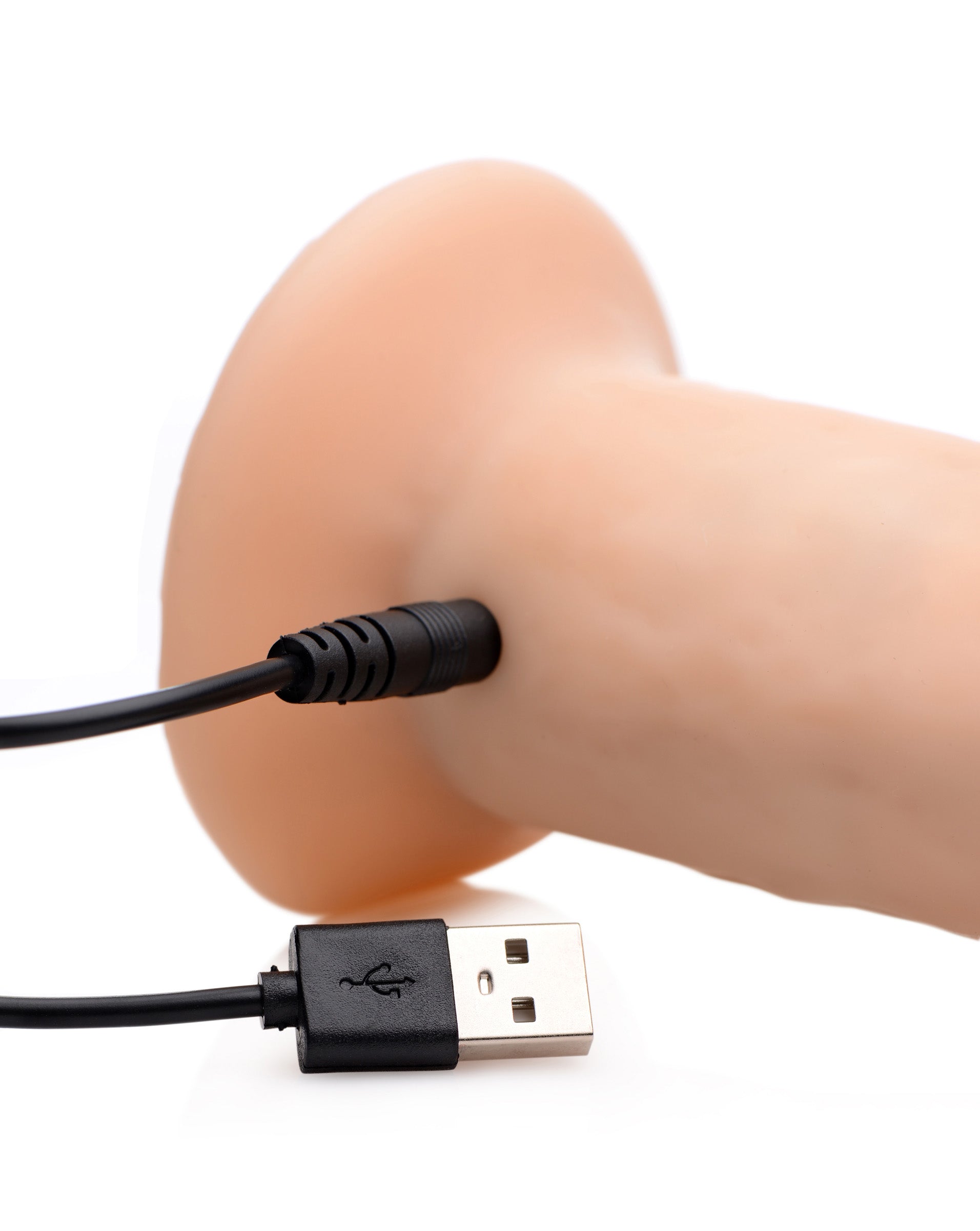 USB charging cable connected to the Kinetic Thumping 7x Dildo