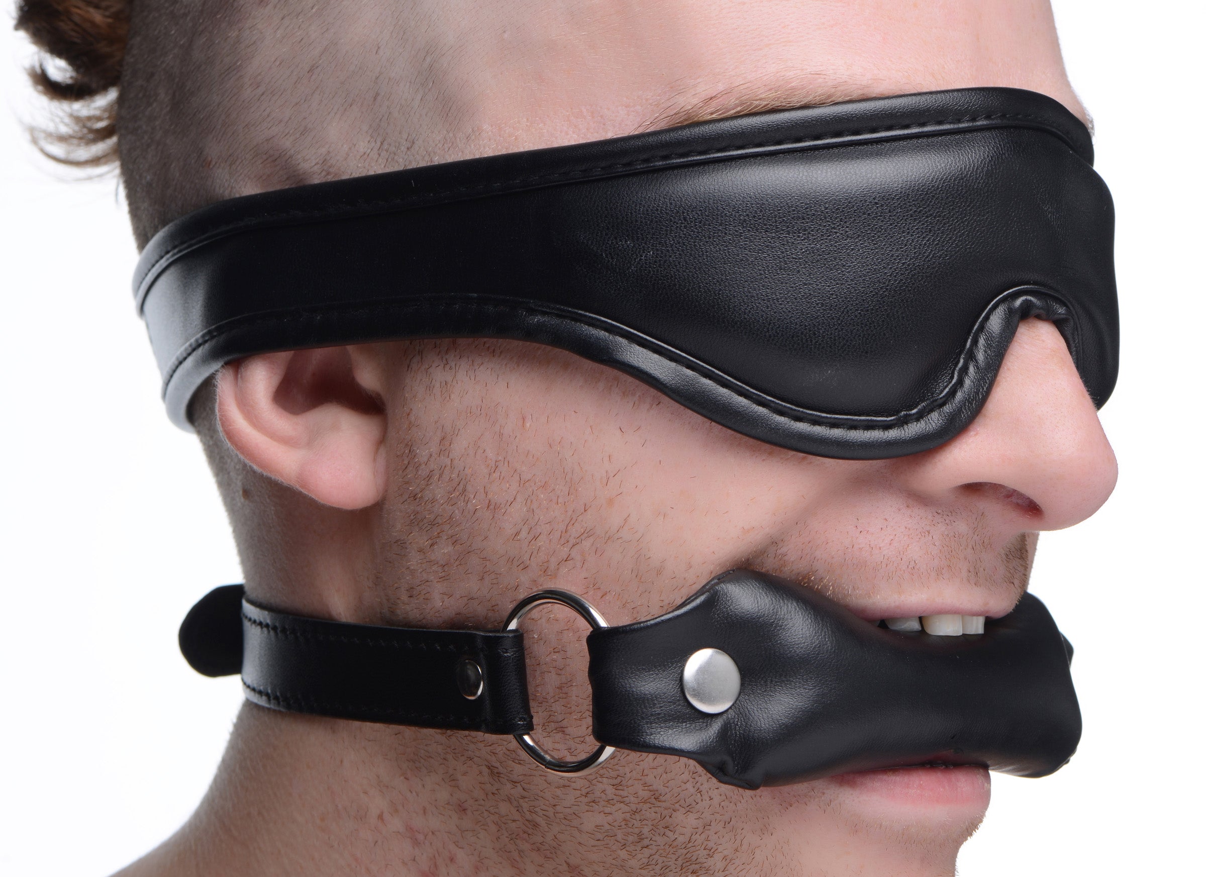 Male model demonstrating the use of the padded blindfold and gag