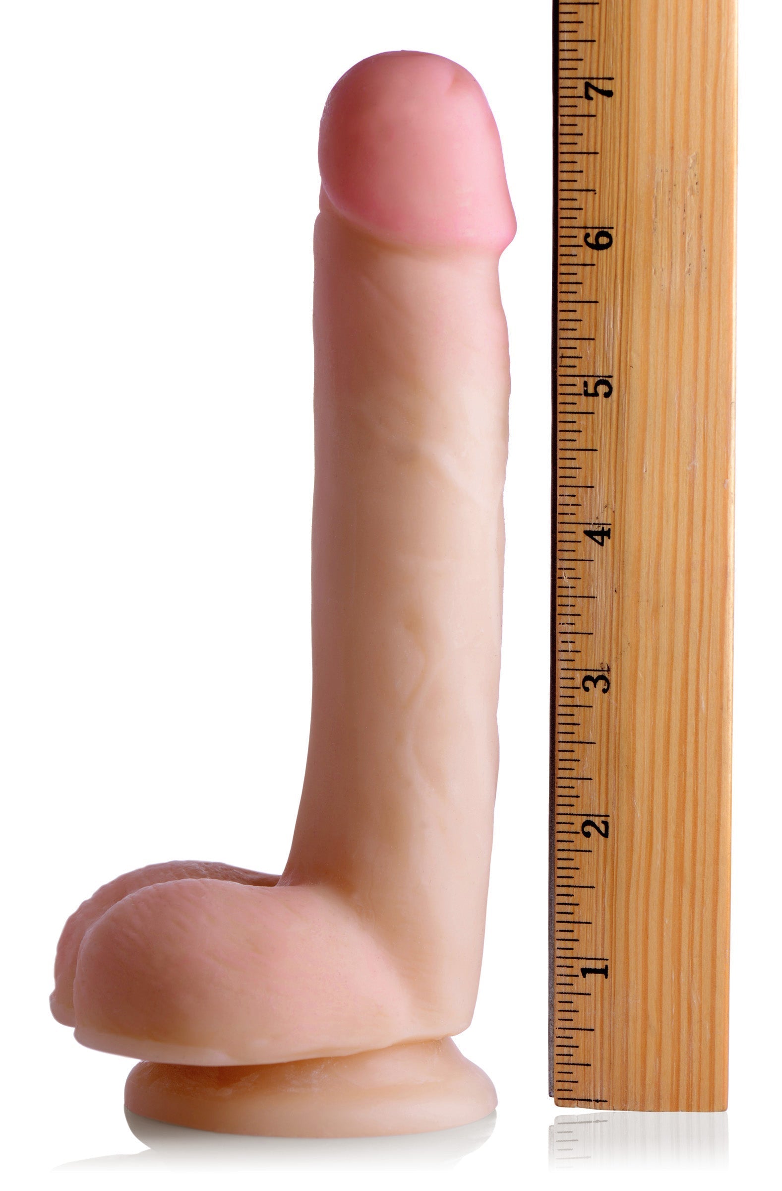 The Slim Skintech Realistic Dildo with Balls shown with a ruler for scale