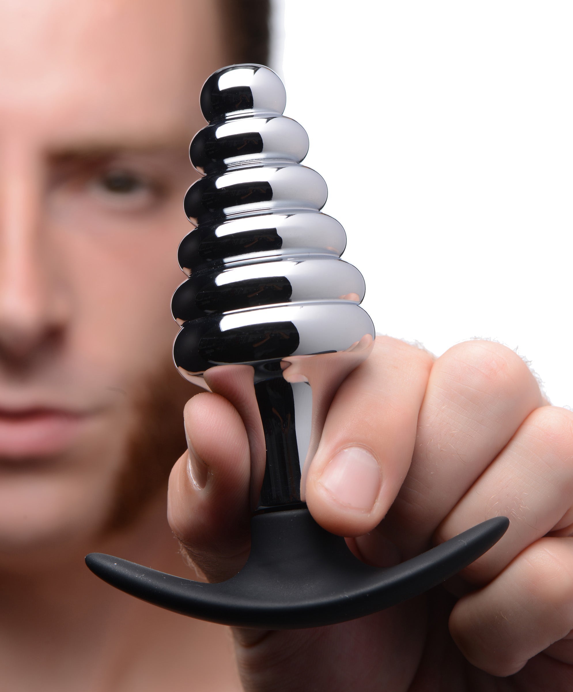 Person holding the Dark Hive Metal and Silicone Ribbed Anal Plug