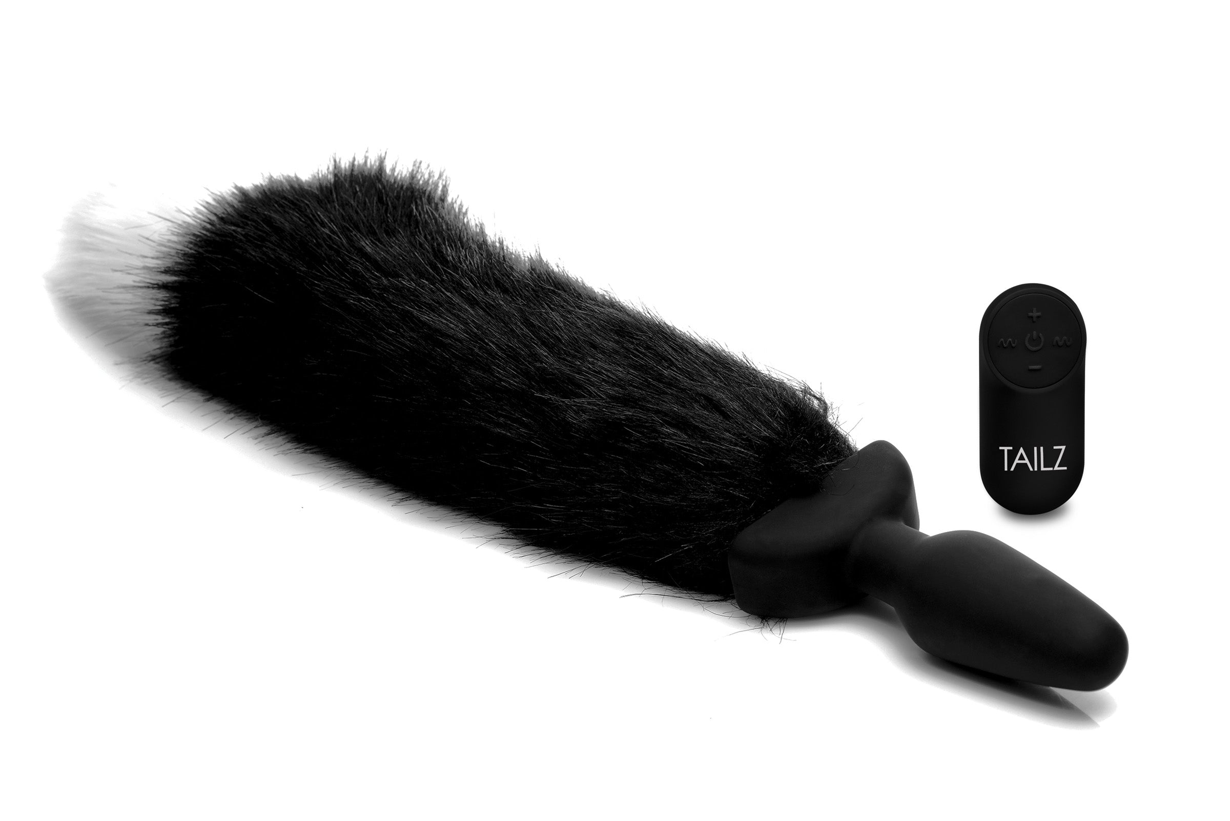 Fox tail anal plug with a wireless remote control on a white background