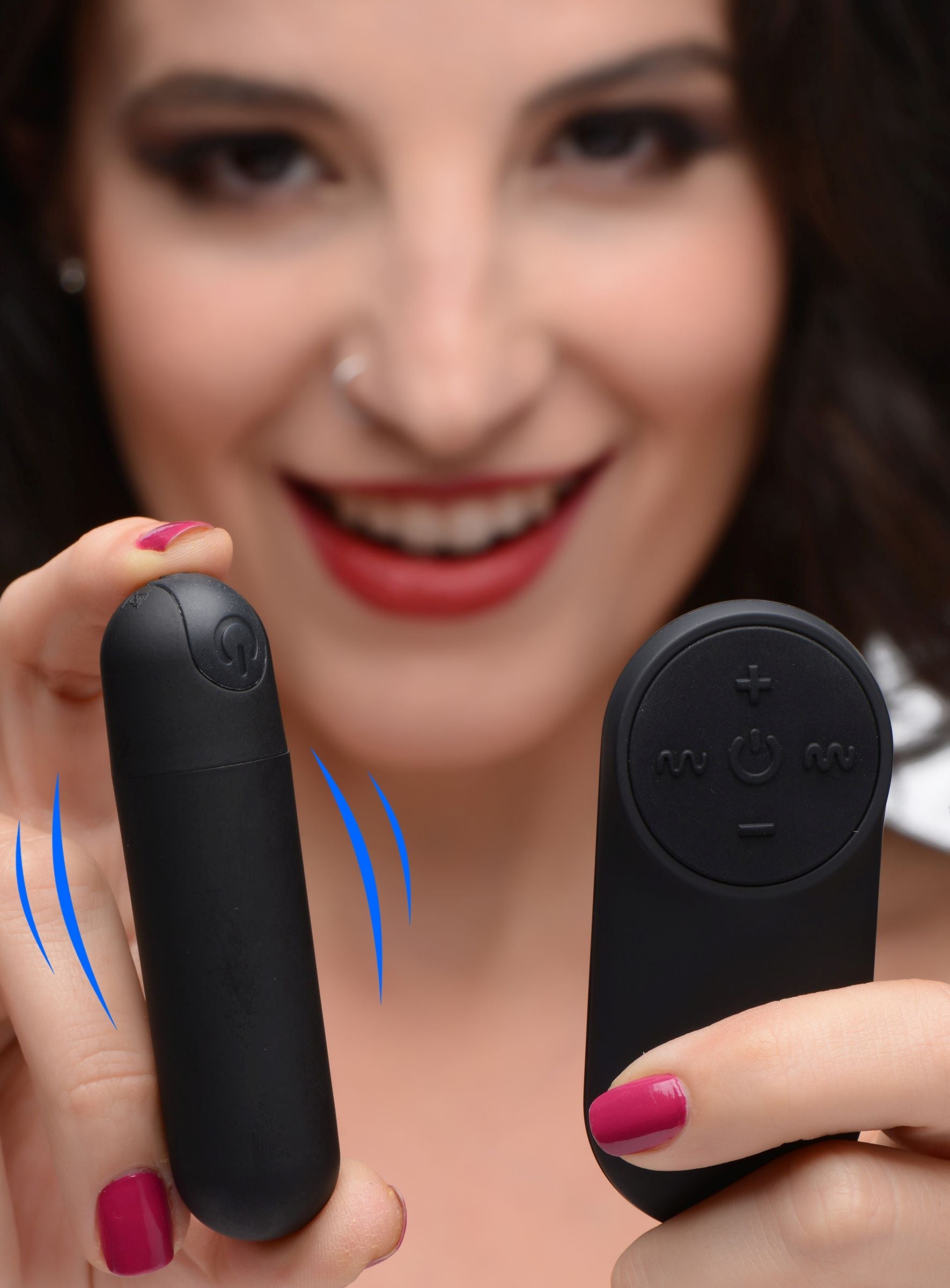 Close-up of a woman's hand holding a remote control for the vibrating bullet