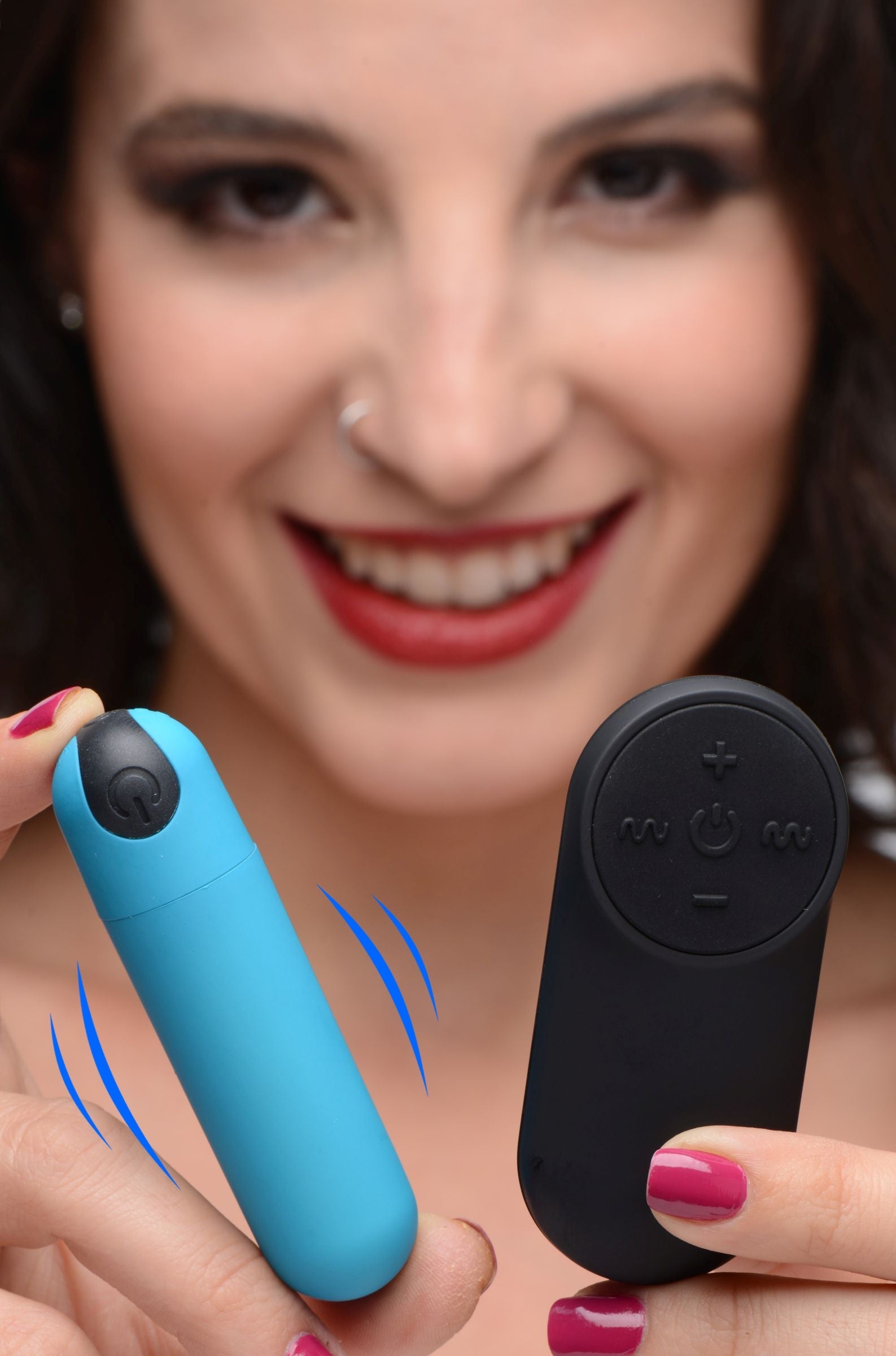 Detailed view of a woman operating the remote control for the vibrating bullet