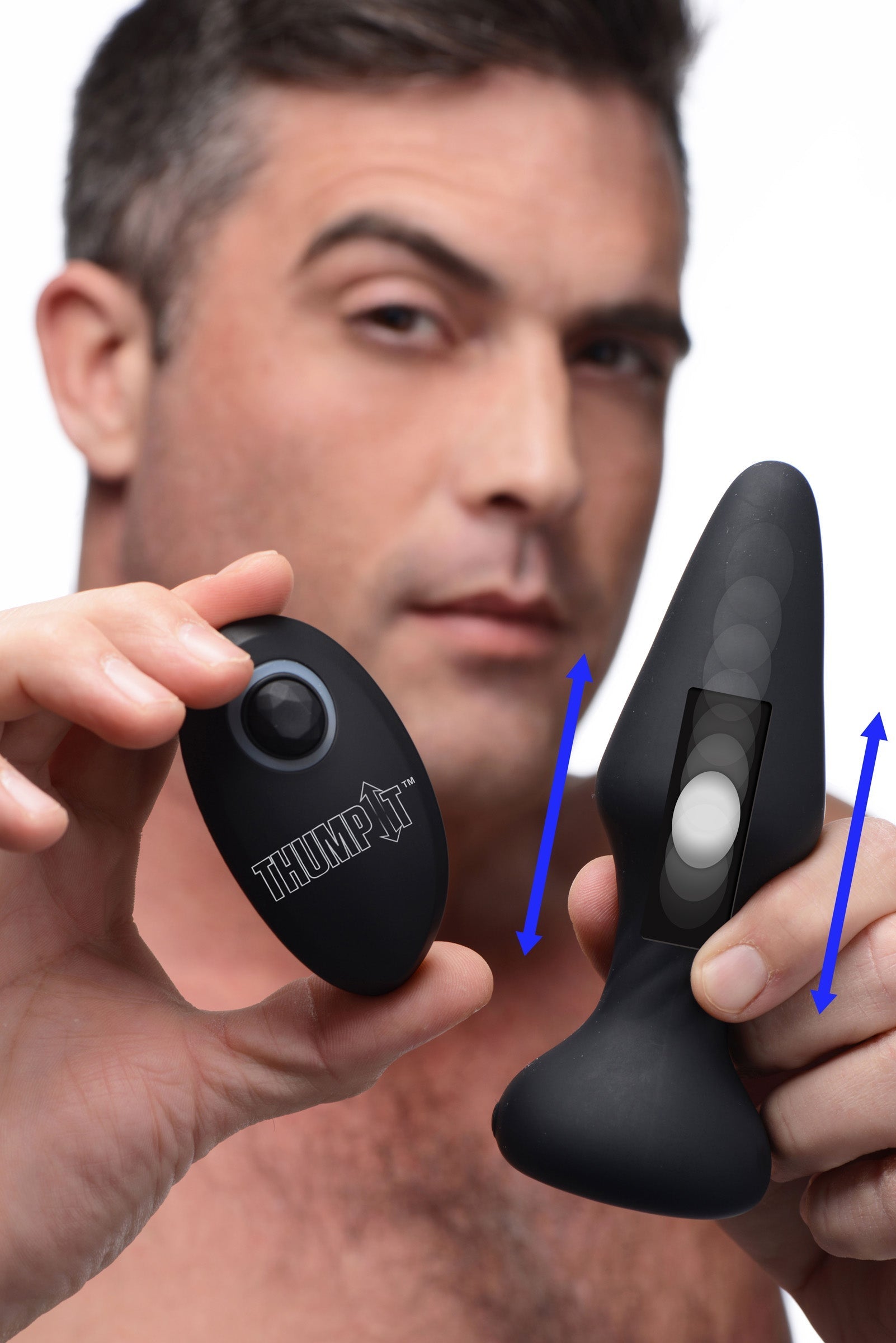 Person holding a black silicone anal plug with thumping feature