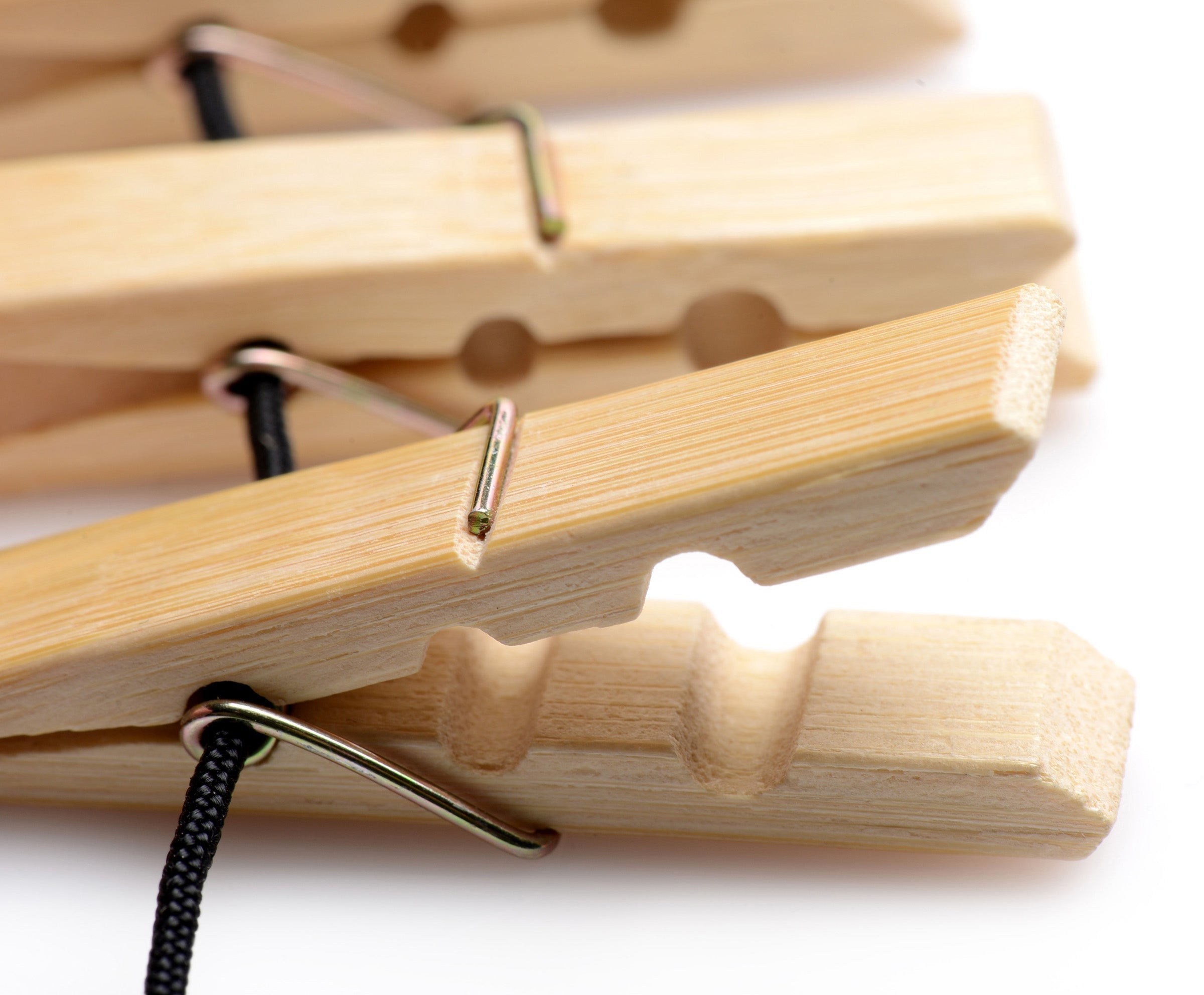 Detail view of the Firecracker Clothespin Body Zipper's wooden pegs and metal clip