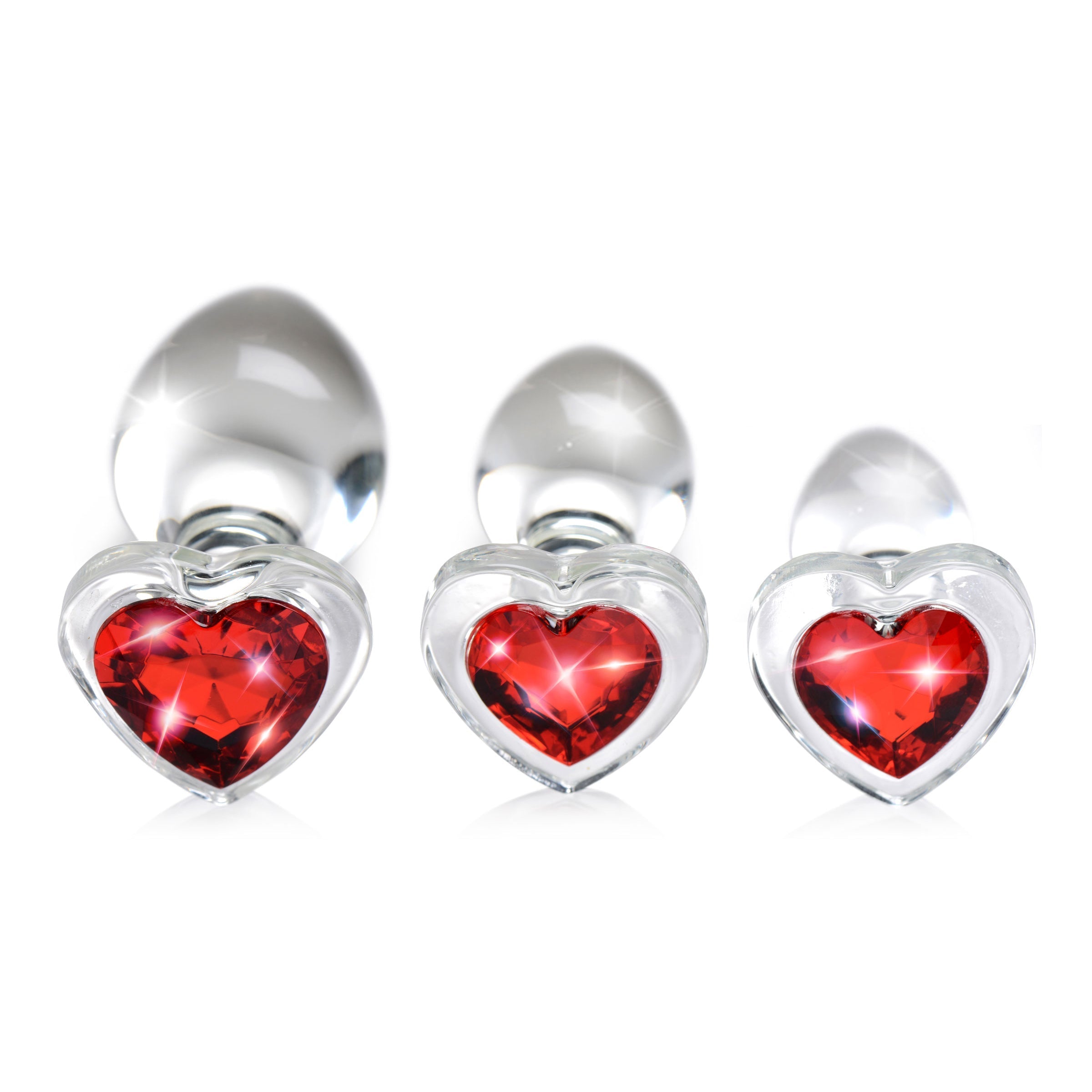 Trio of red crystal heart glass anal plugs on display