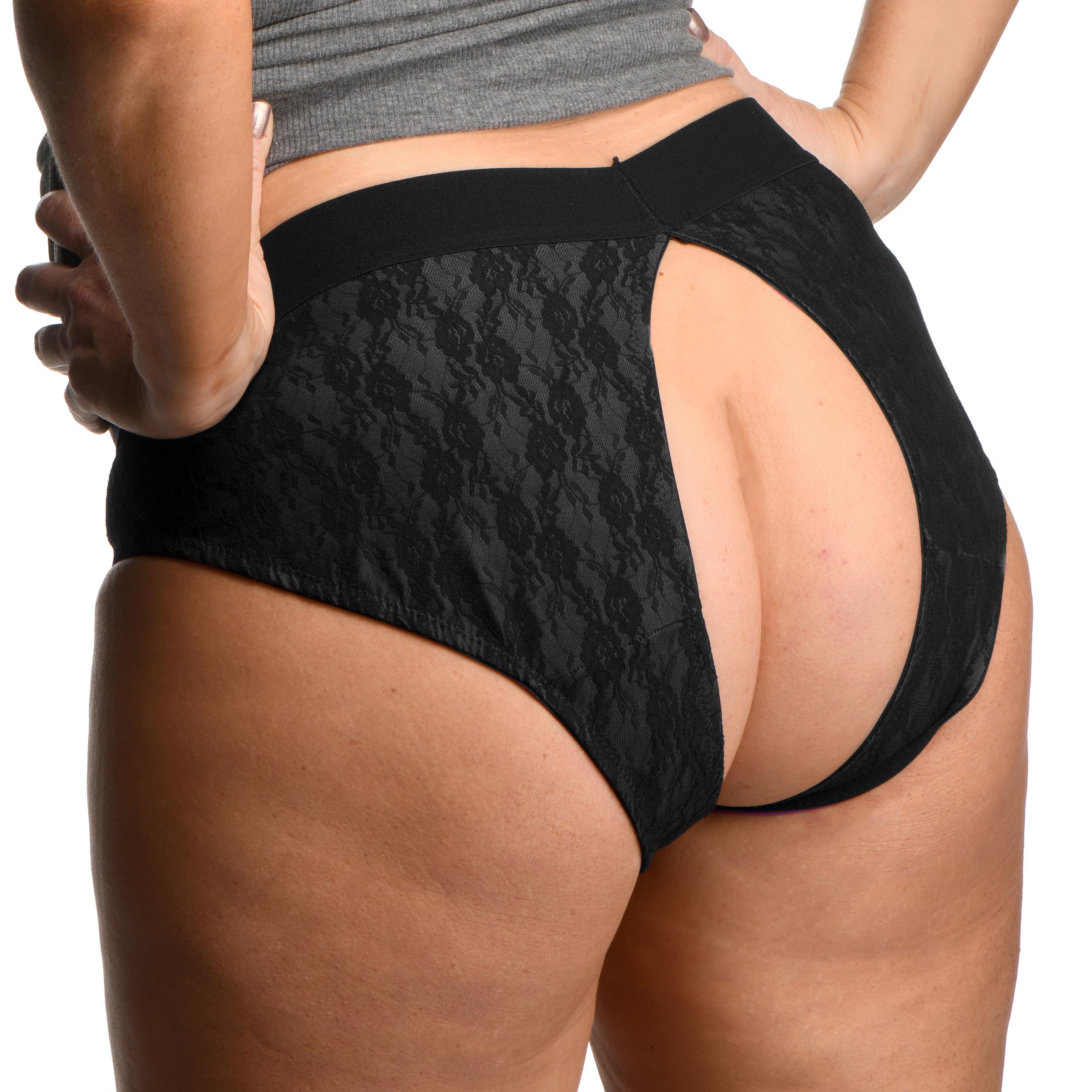 Rear view of the Lace Envy Black Crotchless Panty Harness worn by a model