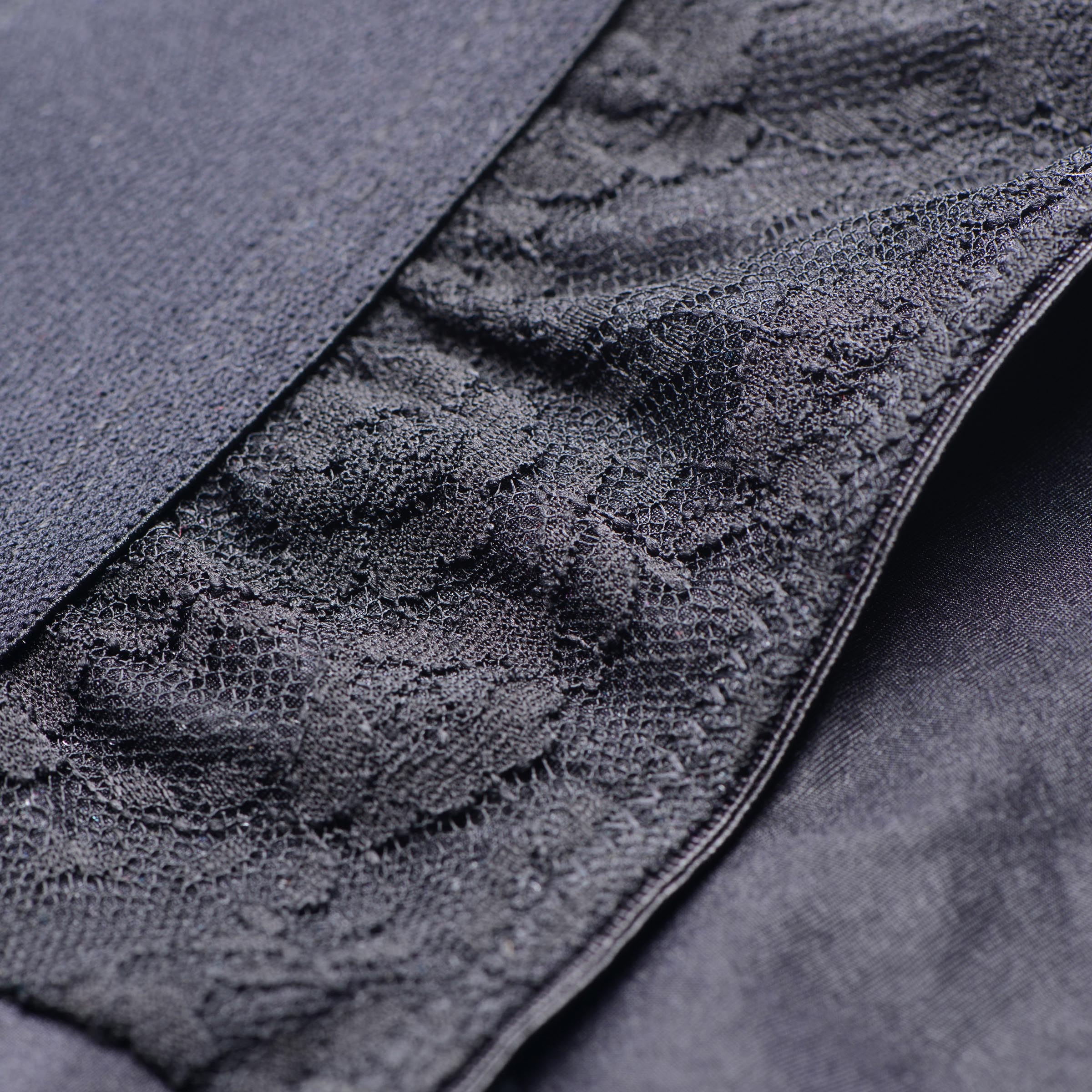 Close-up of the intricate lace detailing on the Lace Envy Black Crotchless Panty Harness