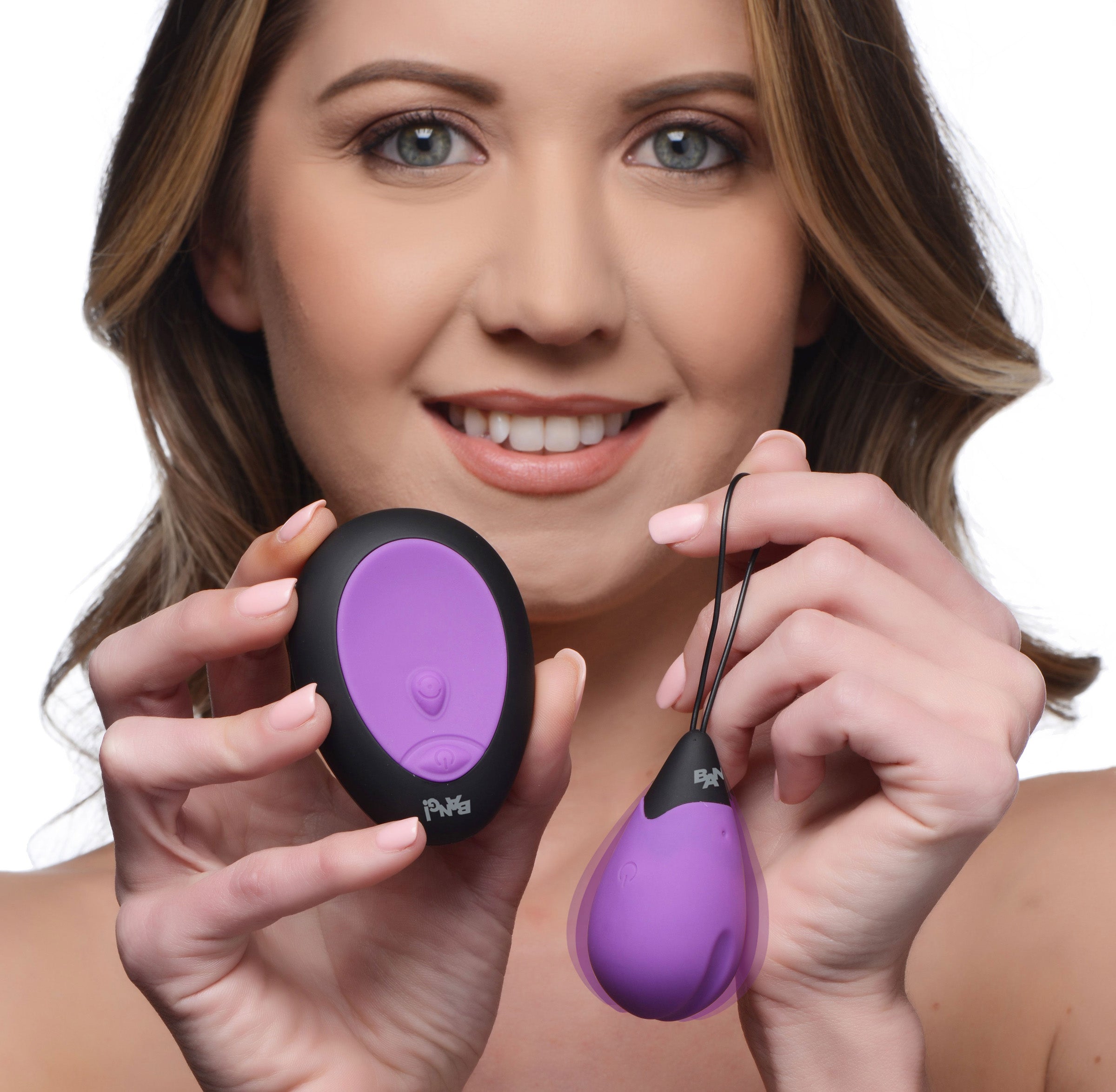 A person holding two purple silicone vibrating eggs