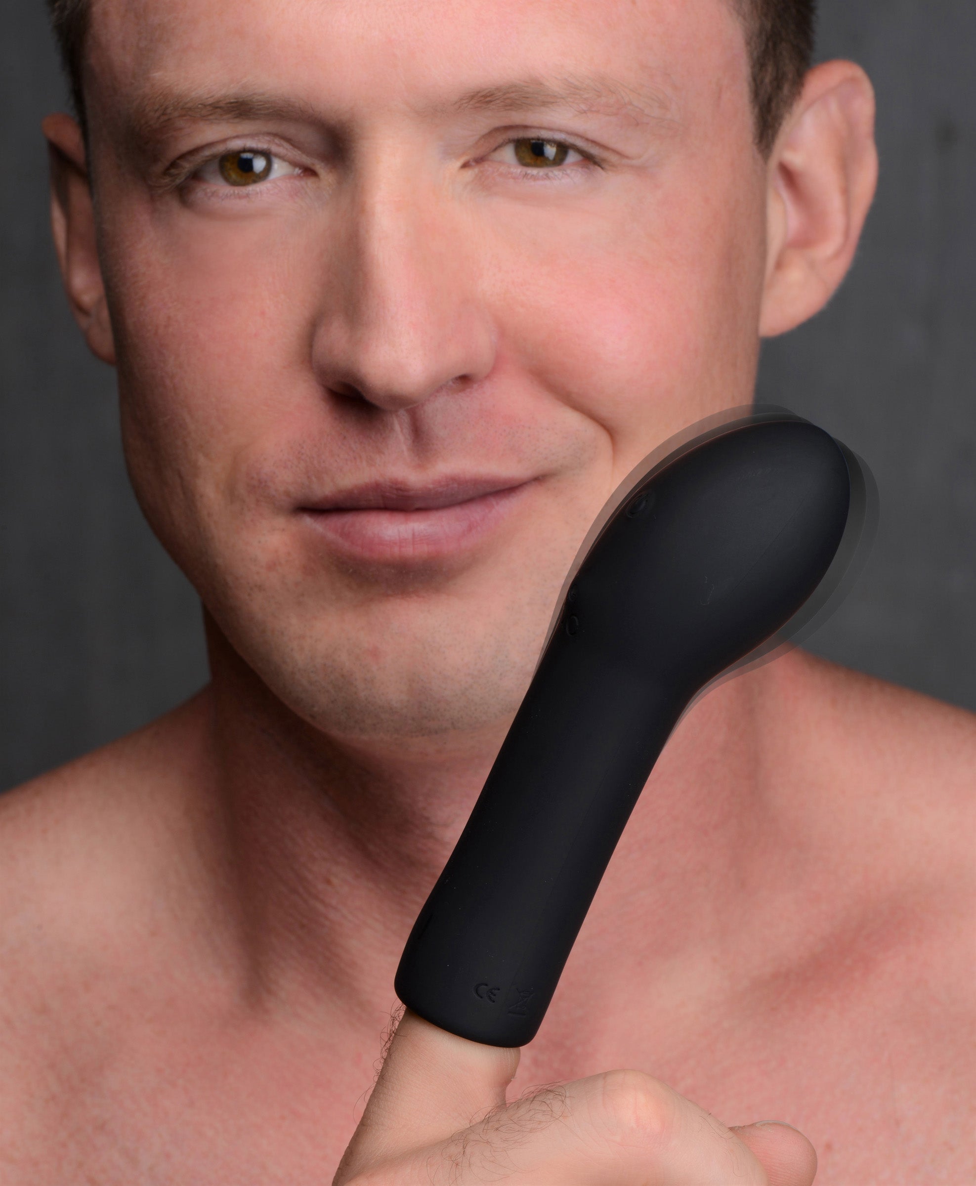 Individual using the vibrating curved silicone finger massager without a shirt