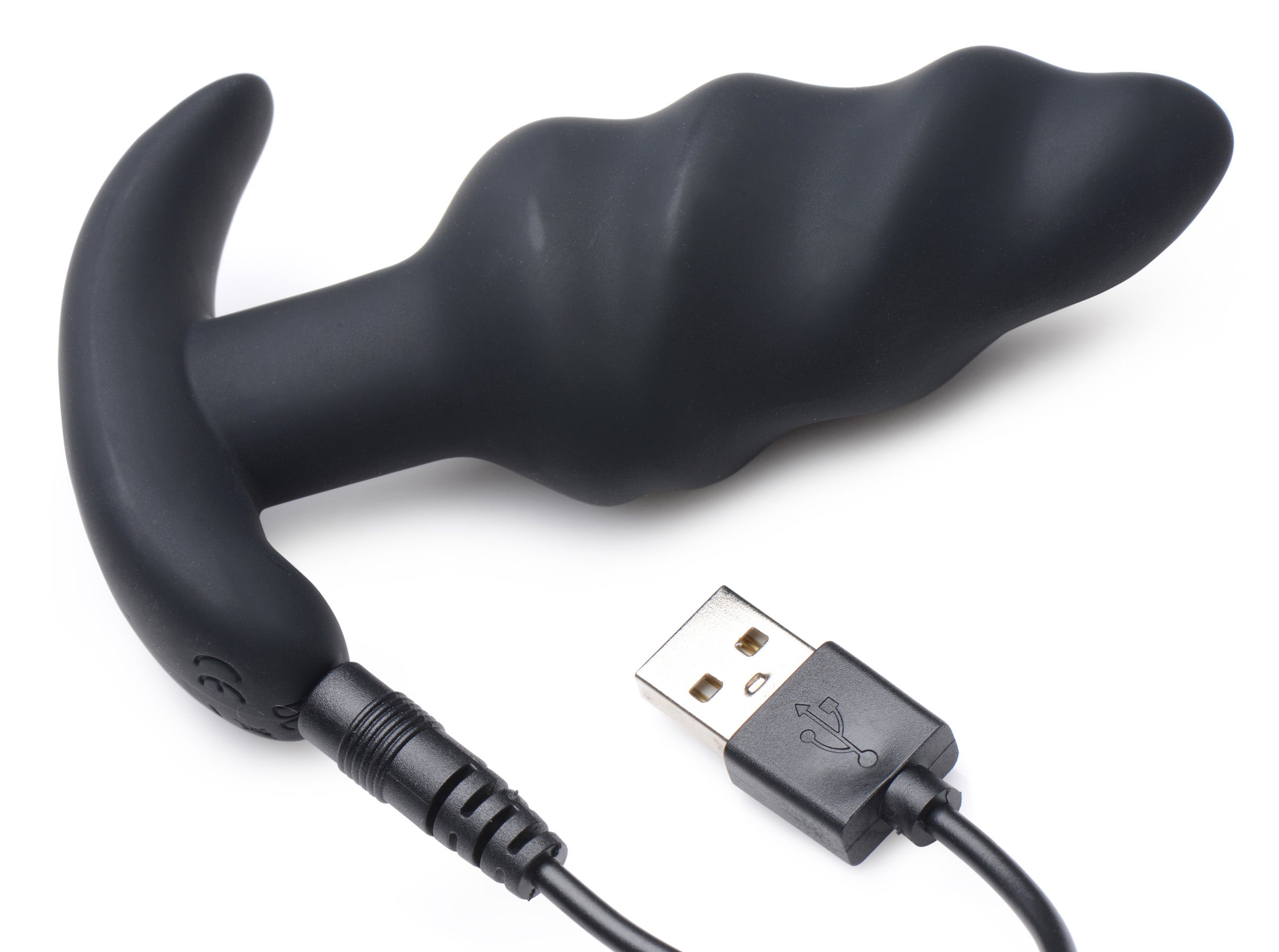 The black silicone swirl butt plug connected to a USB charging cable