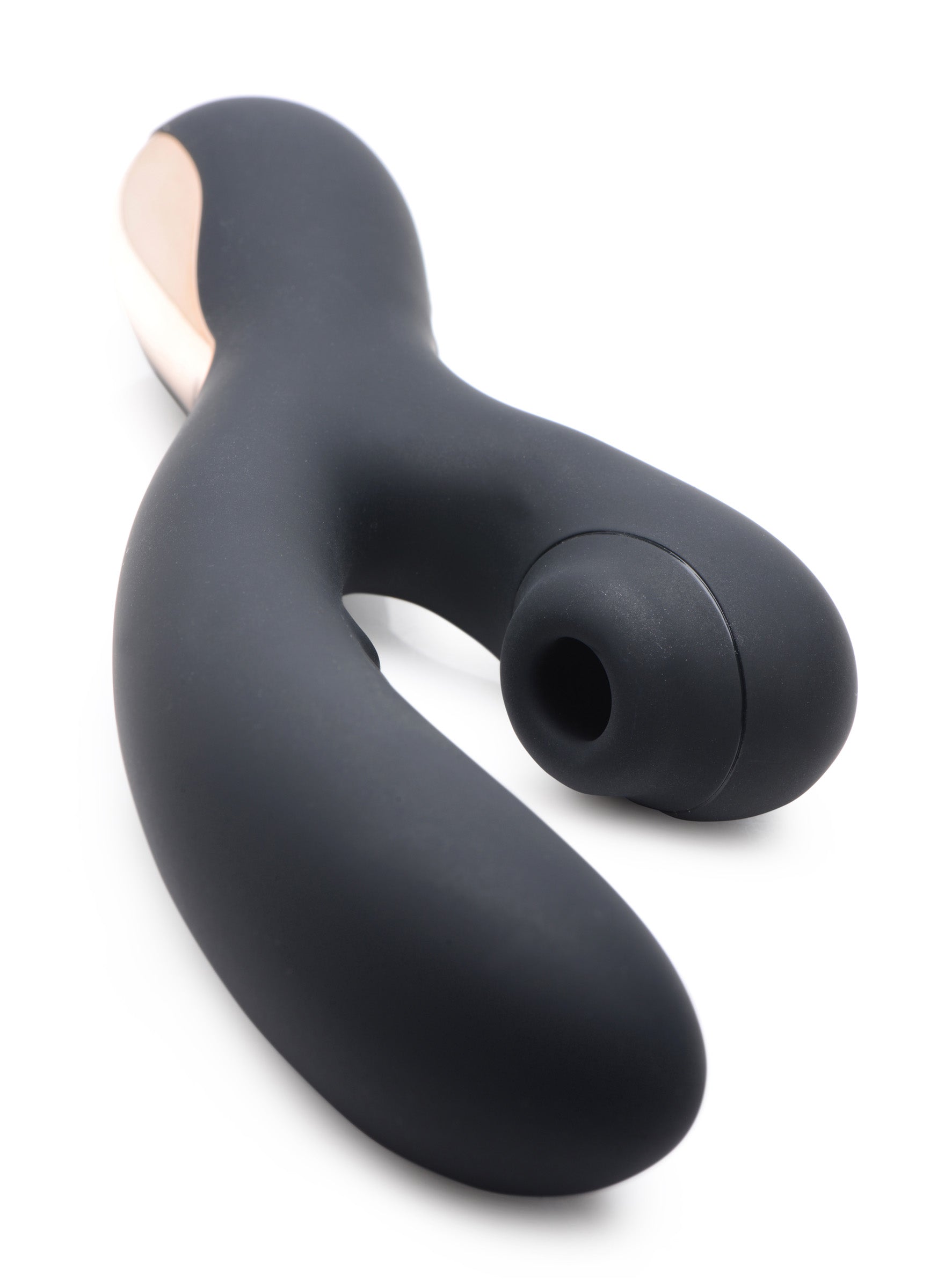 Black and gold silicone suction rabbit vibrator lying on a white surface