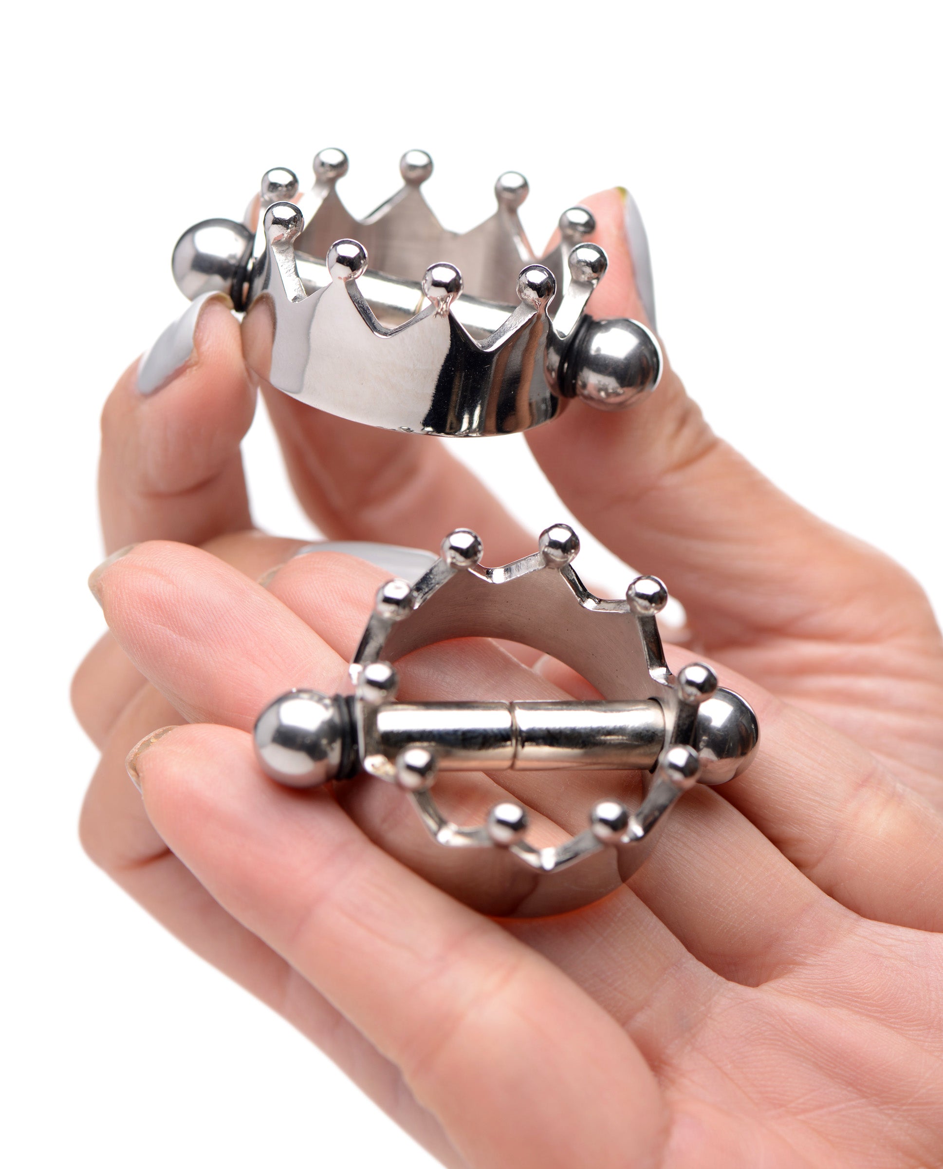 Two individuals demonstrating how to attach Crowned Magnetic Nipple Clamps