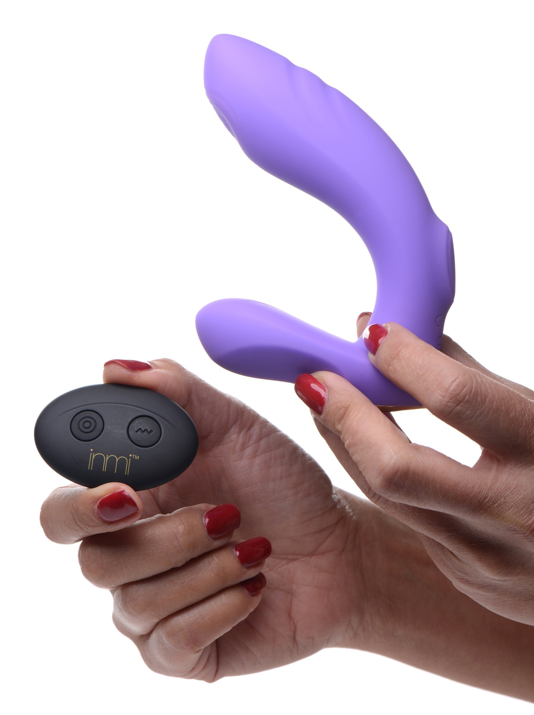 A woman holding the 10x G-tap Silicone G-spot Vibrator with its remote control