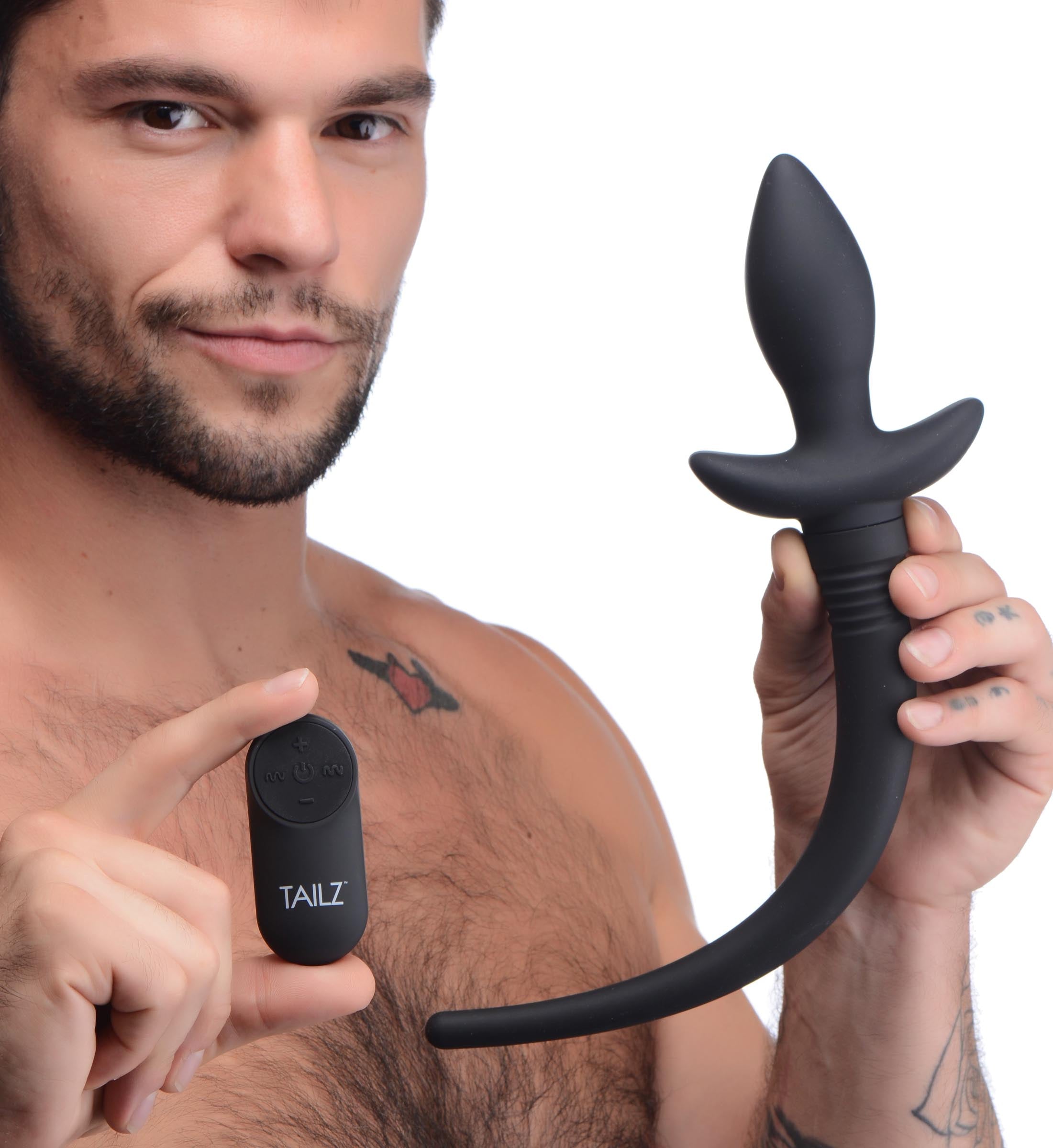 A person presenting the puppy tail anal plug alongside its packaging