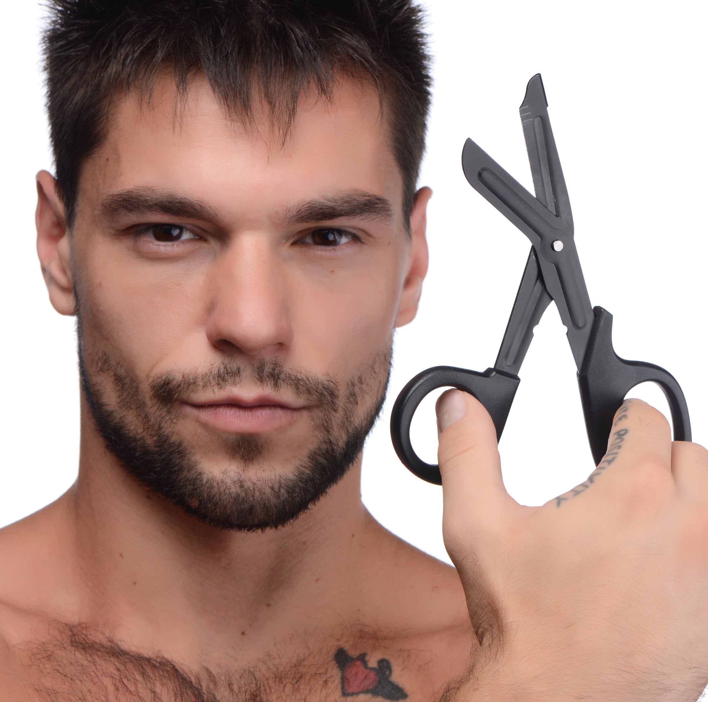 Tattooed individual demonstrating the use of heavy-duty bondage scissors