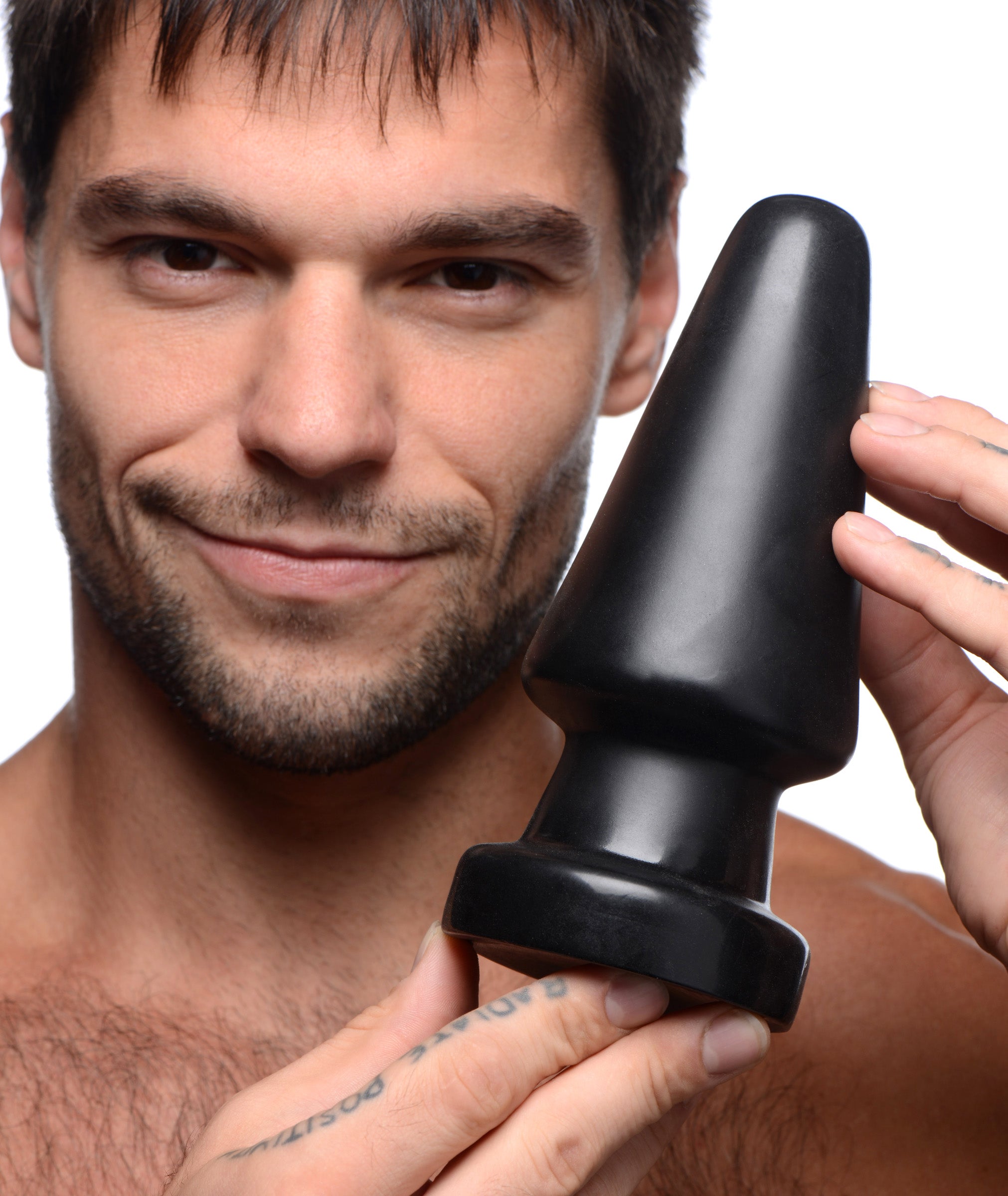 A person holding the Ass Max Large Anal Plug