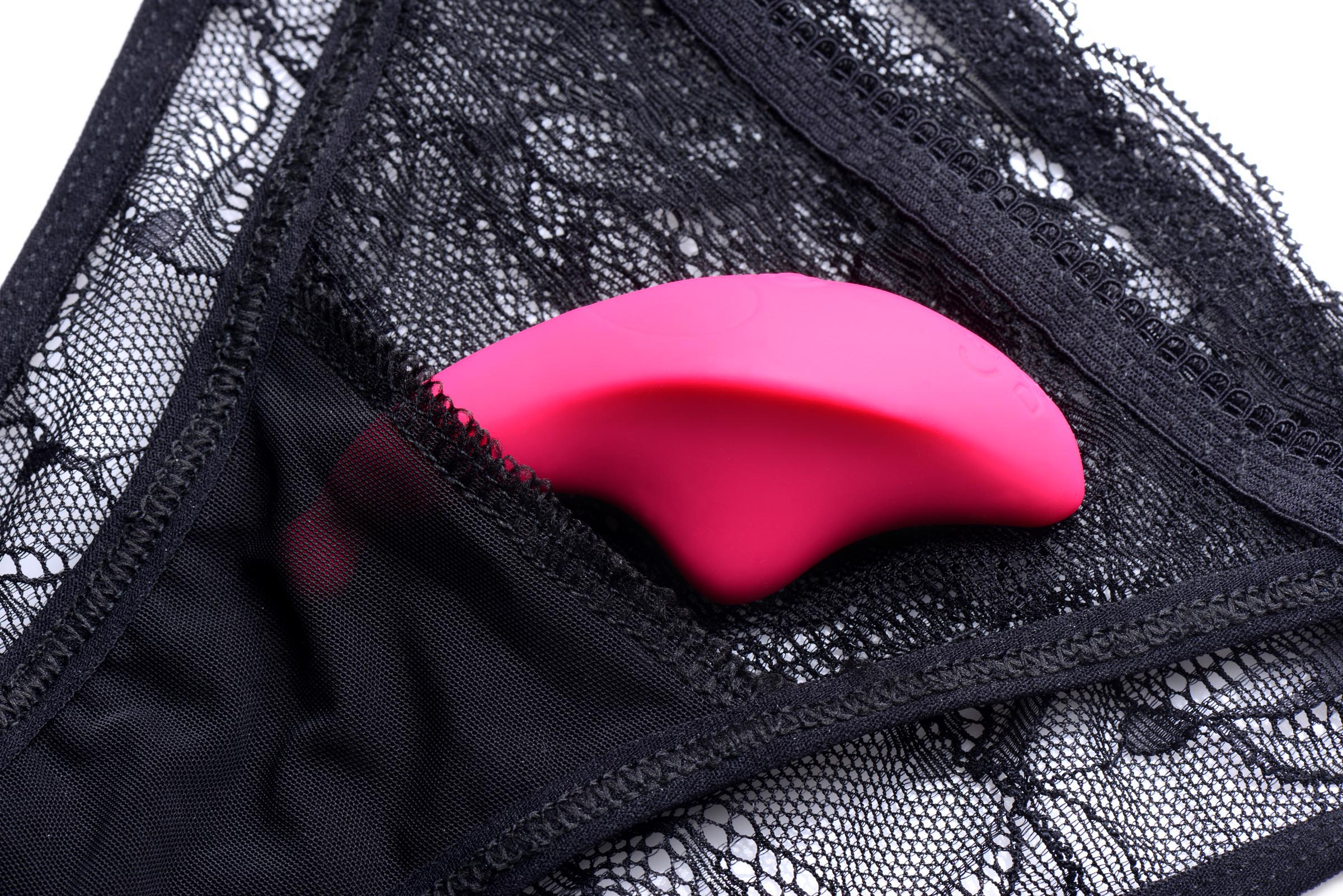 Pink panty vibrator placed inside black lingerie