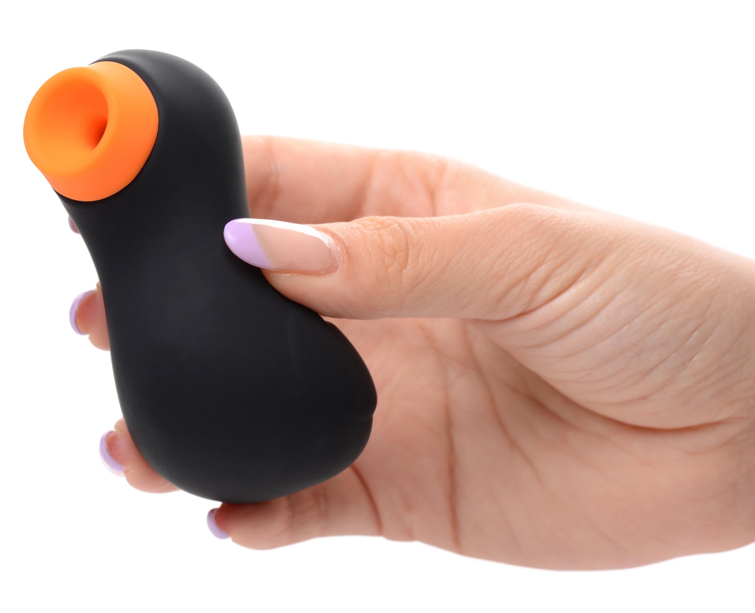 Hand holding the Sucky Ducky clitoral stimulator in black and orange