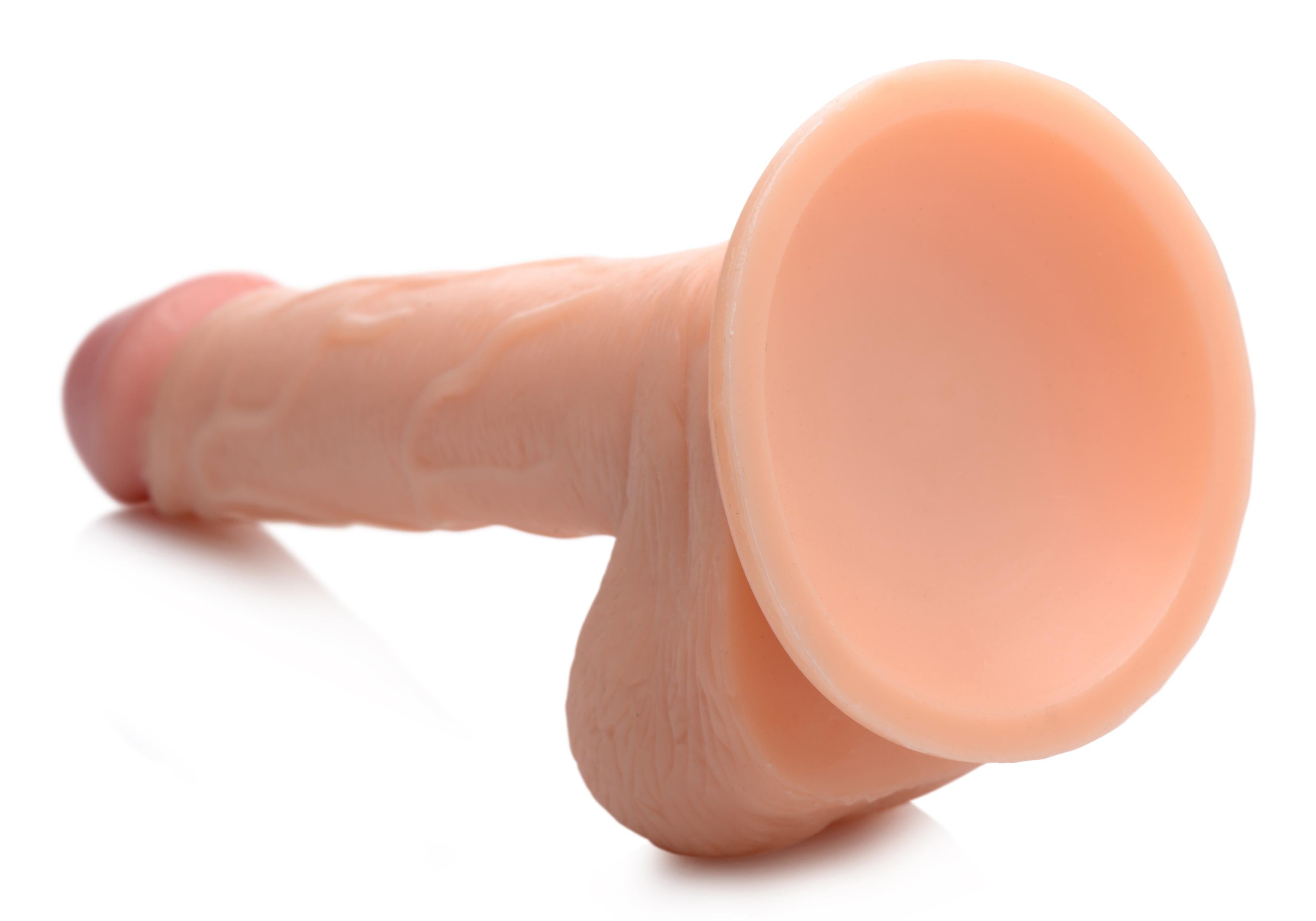 A 7.5-inch realistic dildo with balls against a white backdrop