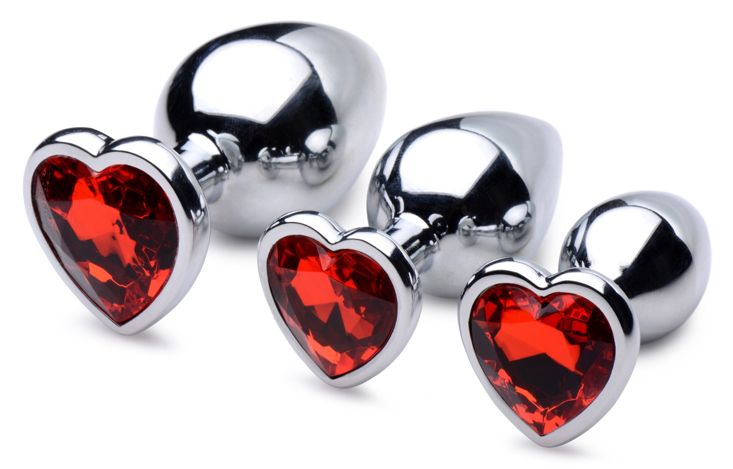 Close-up of three red heart gem anal plugs with sparkling crystals