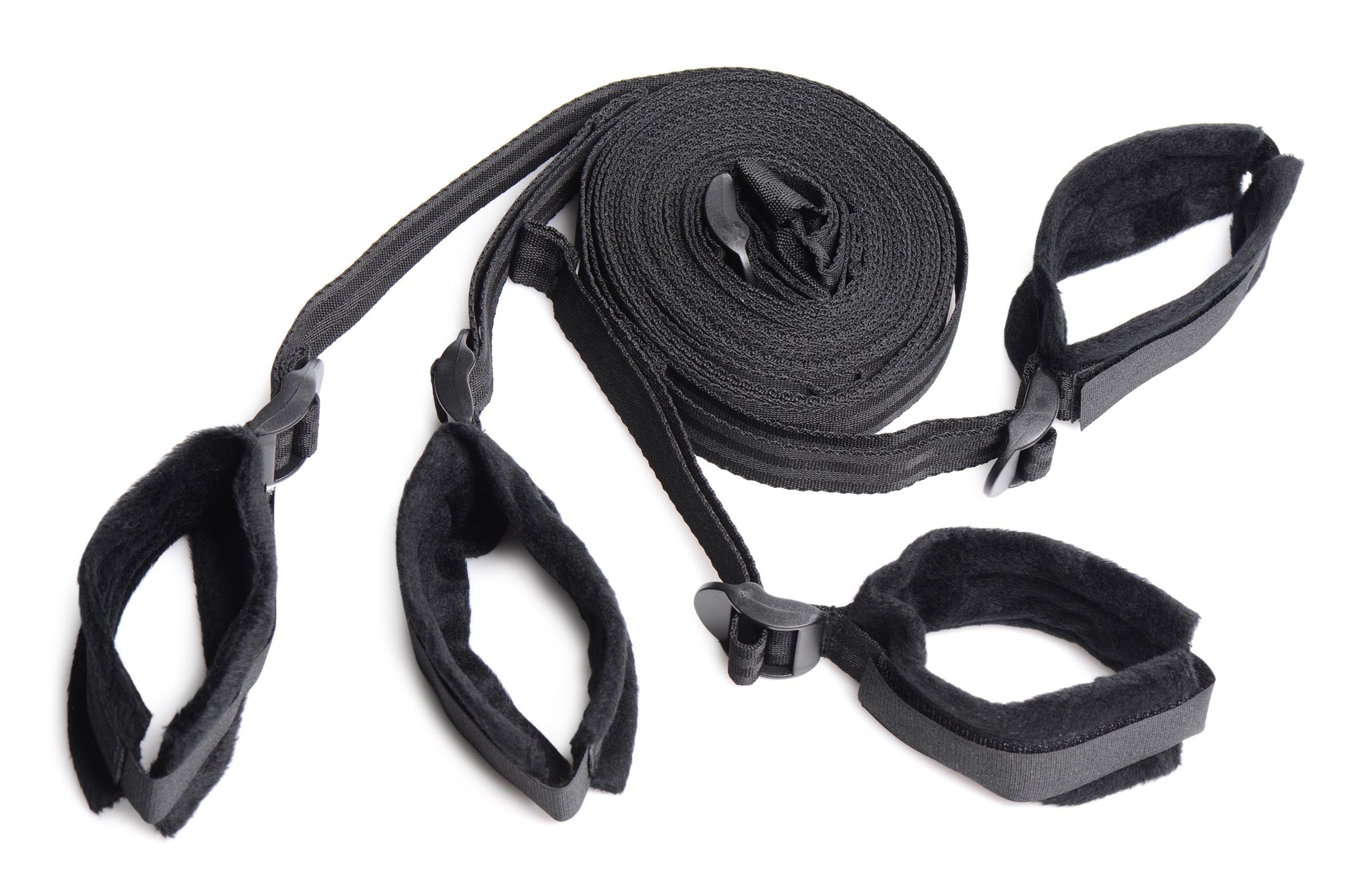 Adjustable black leather thigh straps included in a bondage kit