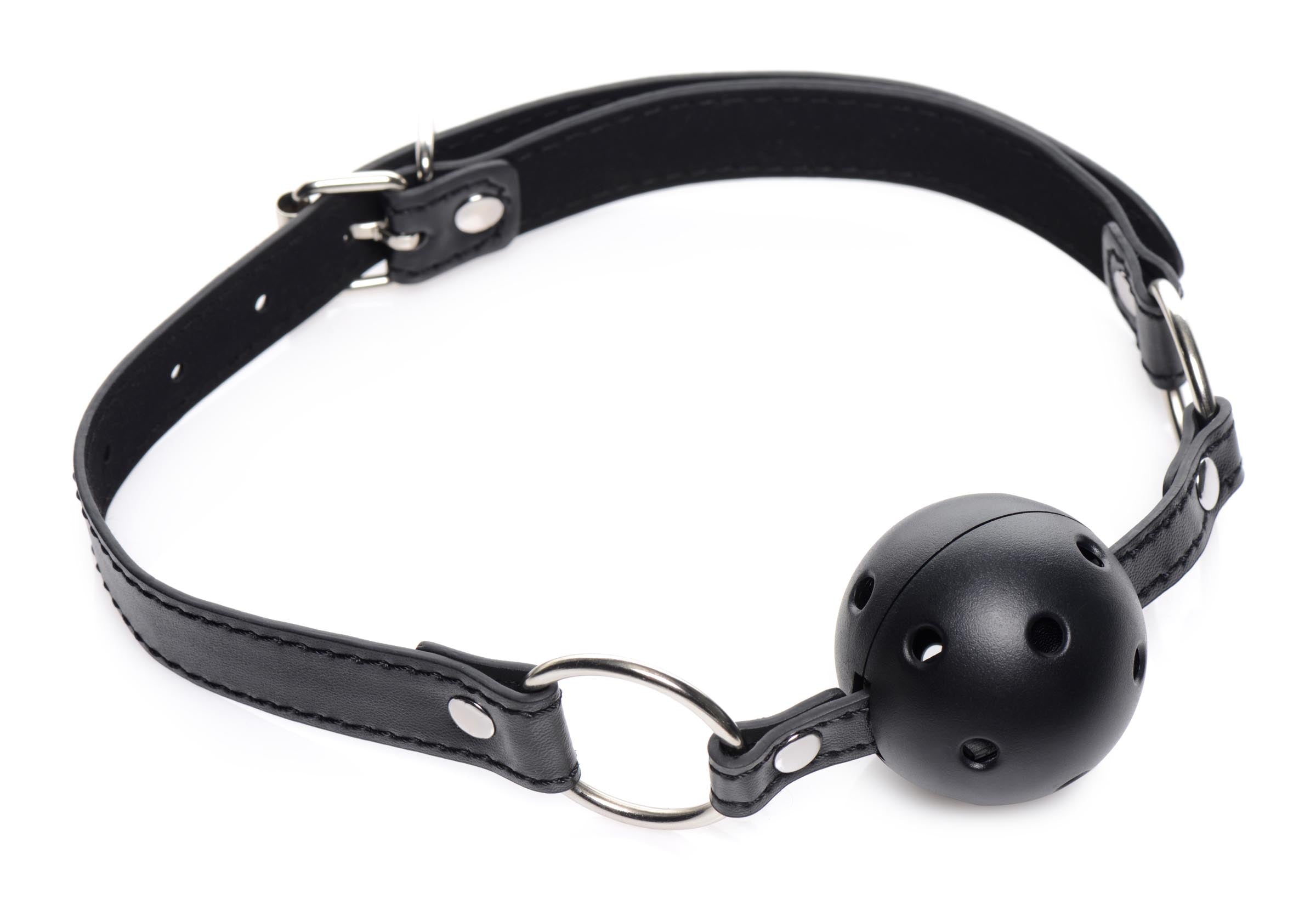 Close-up of a black leather ball gag with adjustable strap